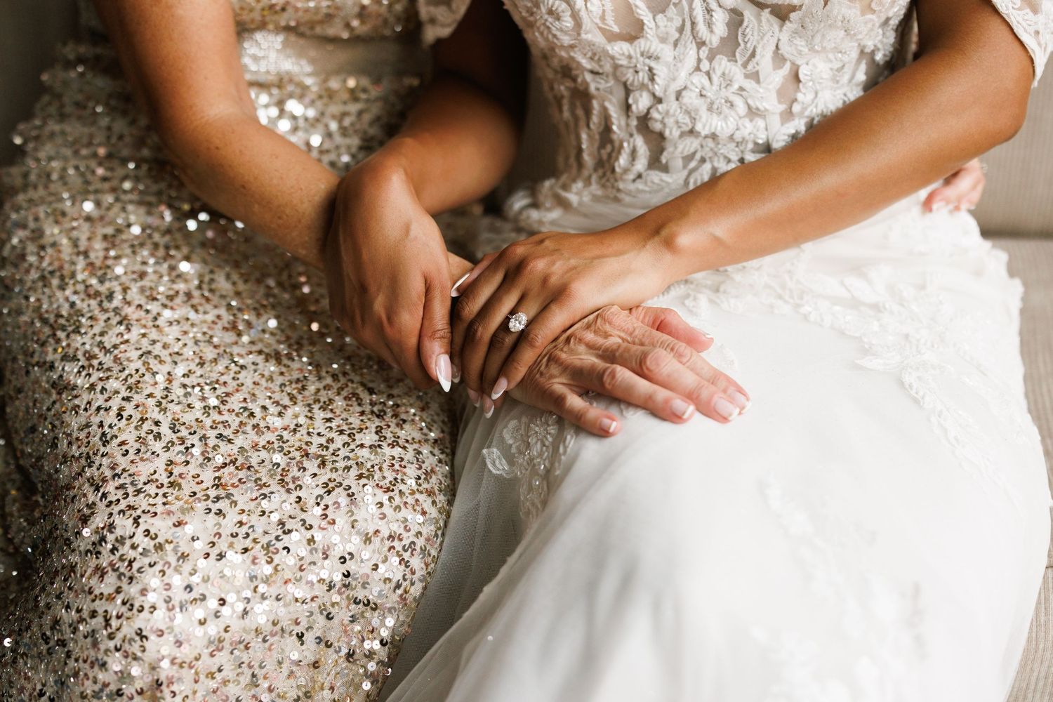 Close-up detail shots of a white lace wedding dress with intricate beading and delicate embroidery patterns.