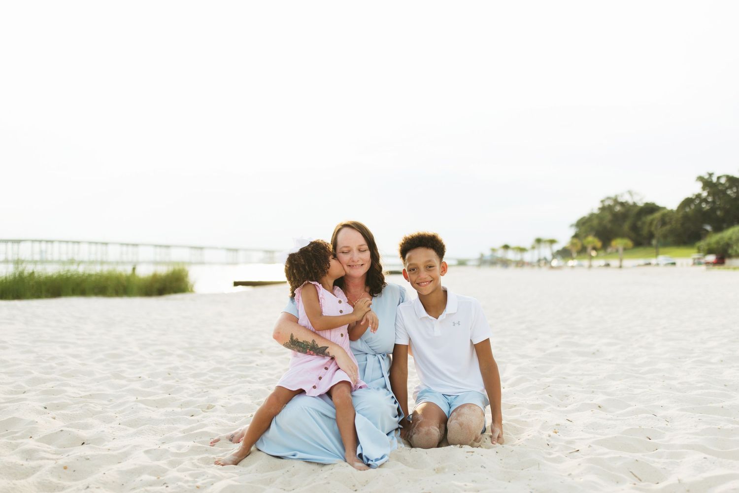 Joyful family moment captured while playing together on a sunny beach.