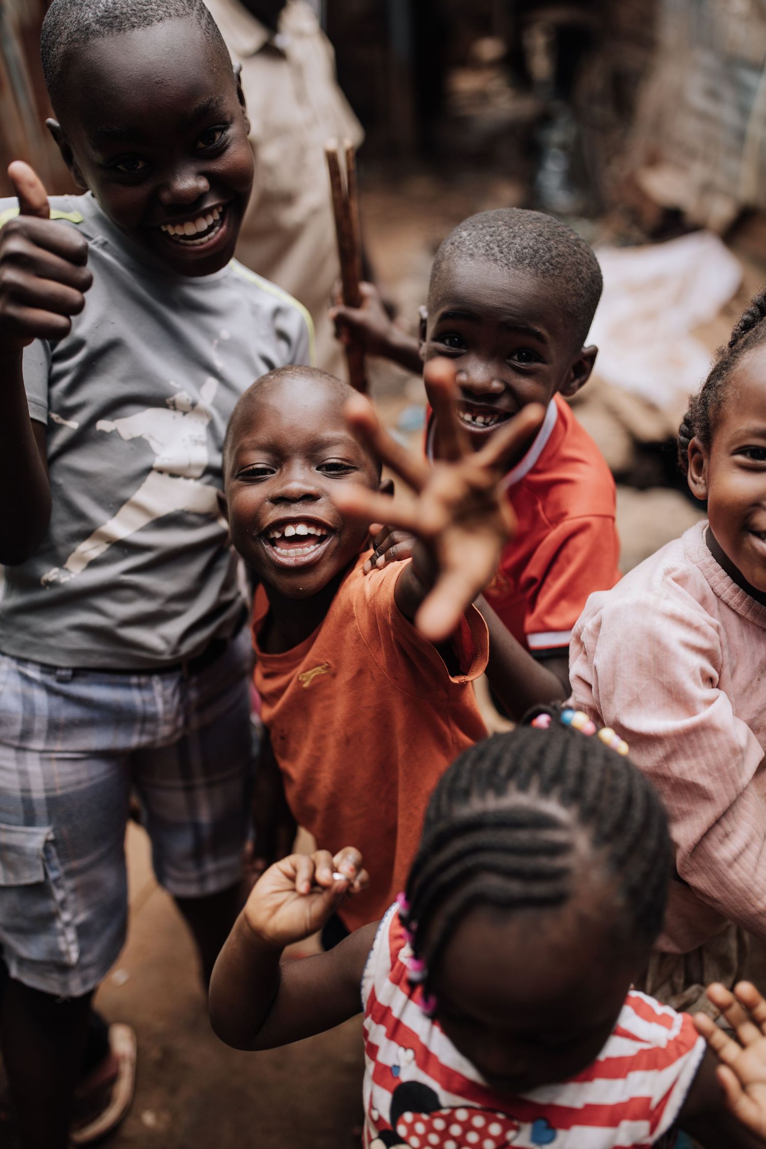 Joyful children laughing and playing together in Africa, showing pure happiness and friendship in candid moment.