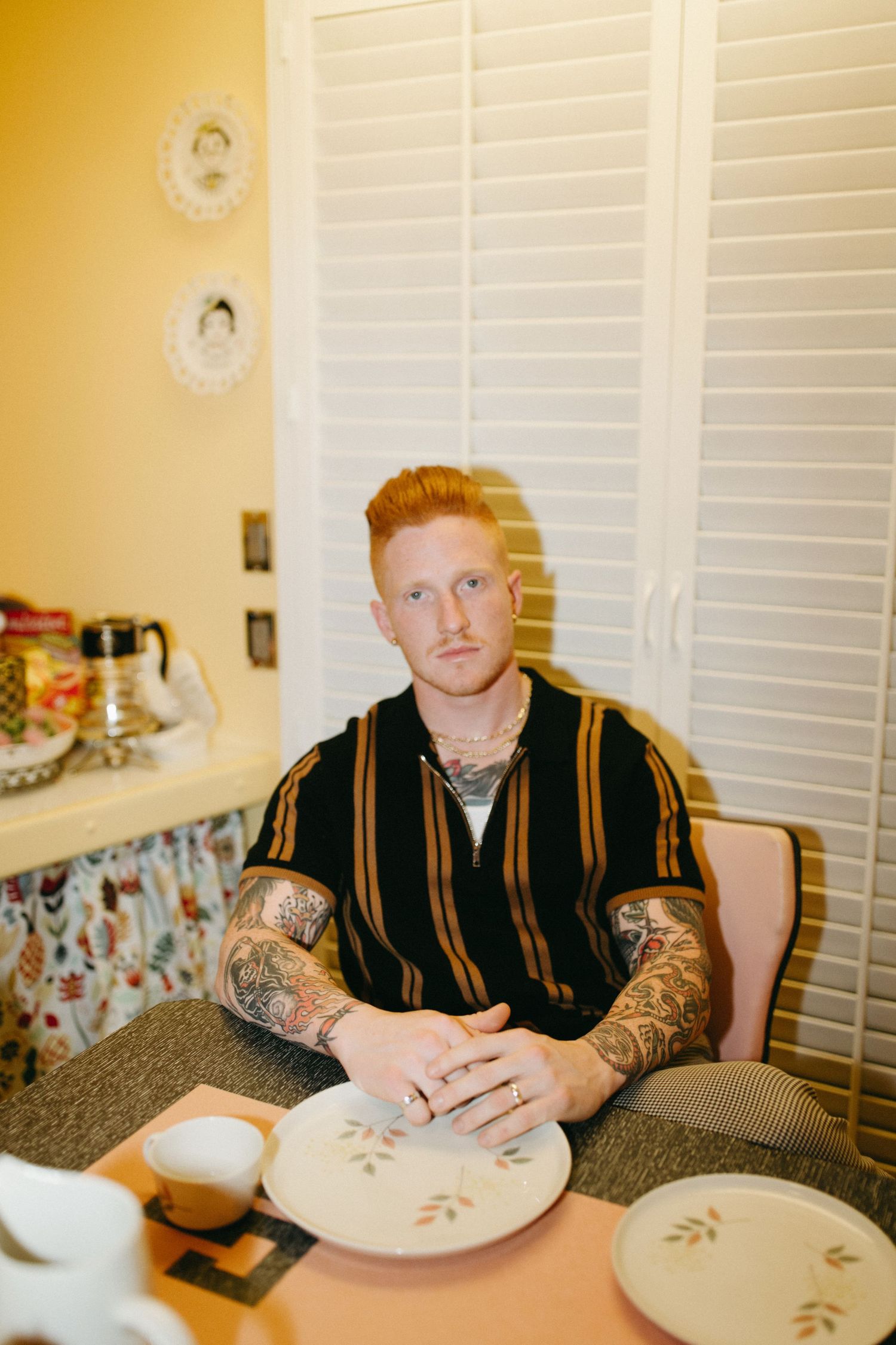 Person falling asleep in four sequential images while sitting at a table with empty plates.