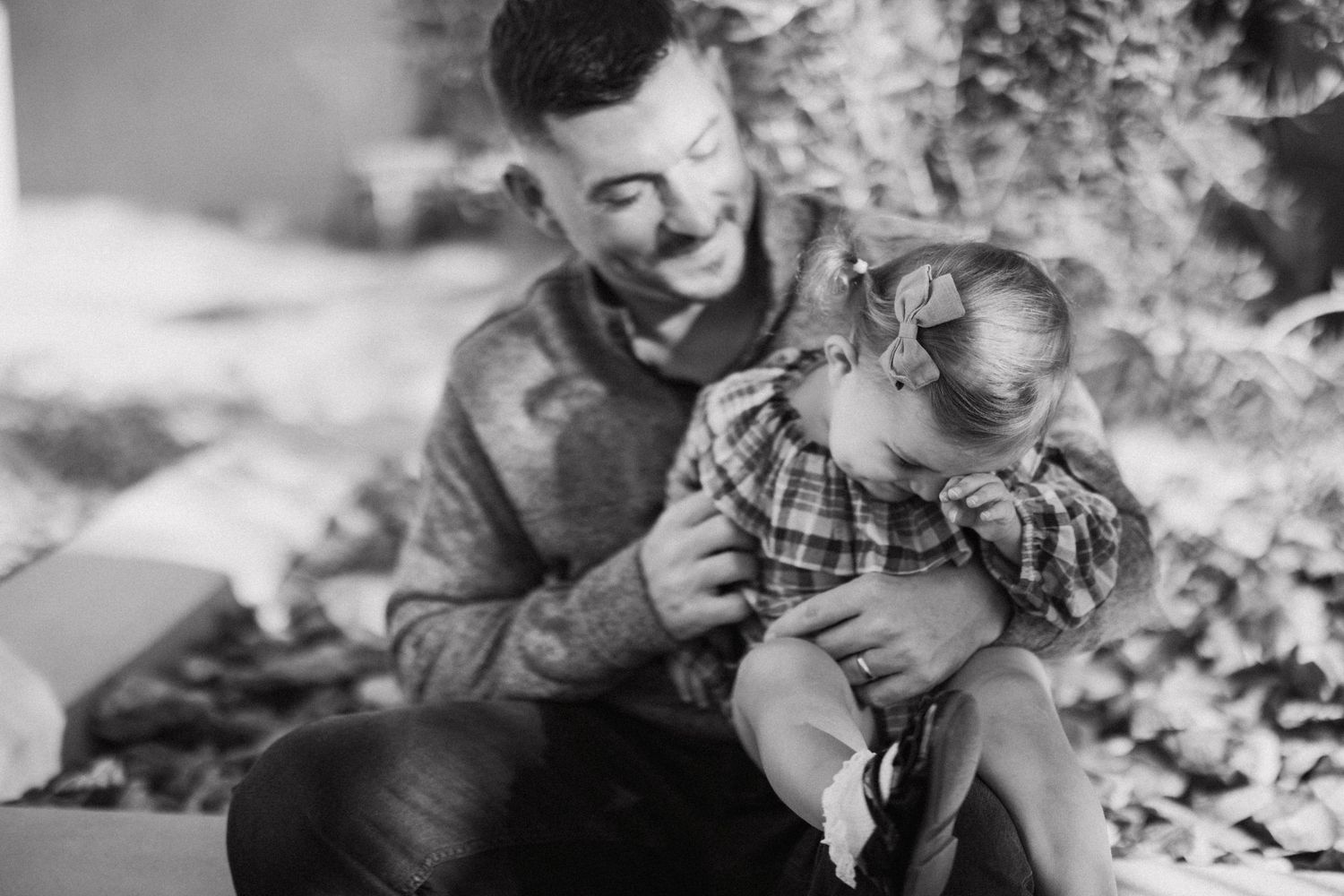 A collage of candid black and white photos showing sweet moments between people in outdoor settings.