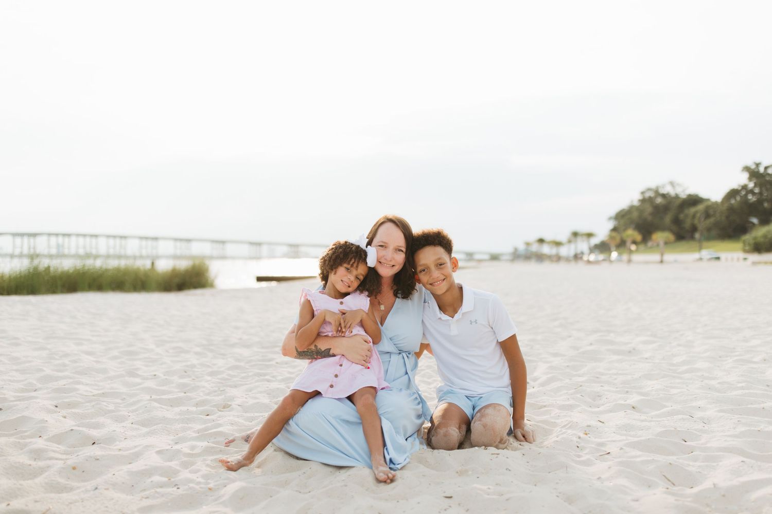 Candid family moment showing playful interactions on a pristine white sandy beach.