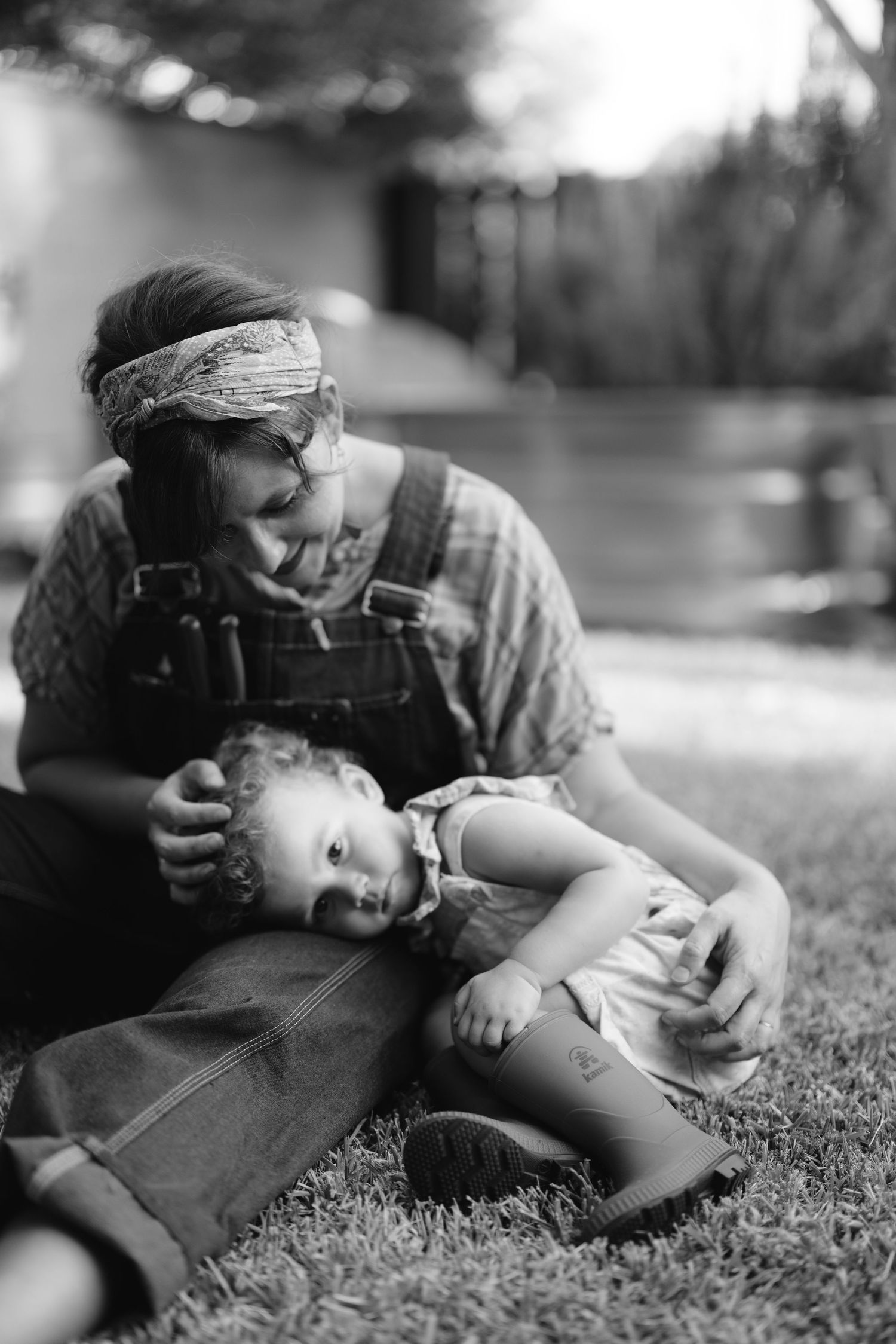 A black and white photo sequence shows two people lying together peacefully on grass.