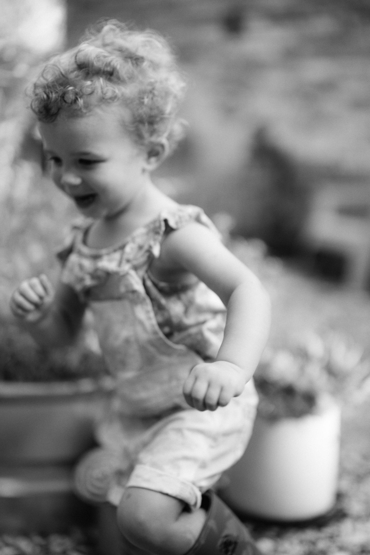 Black and white sequence showing joyful movements and expressions of a small child.