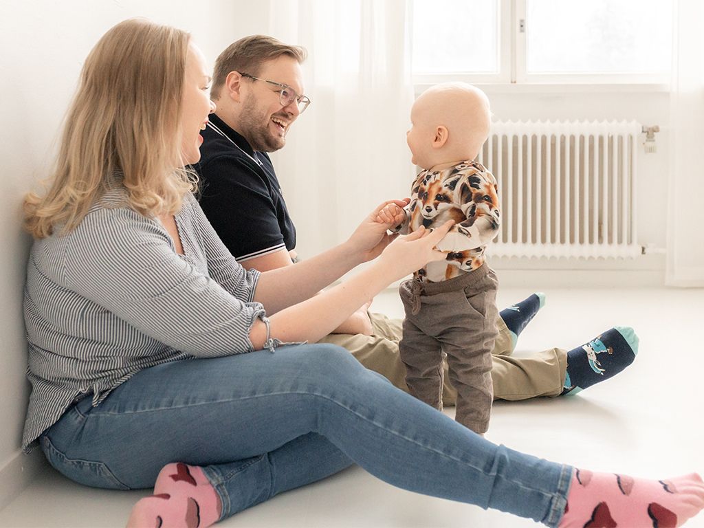 äiti ja isä leikkii lapsen kanssa- perhekuvaus