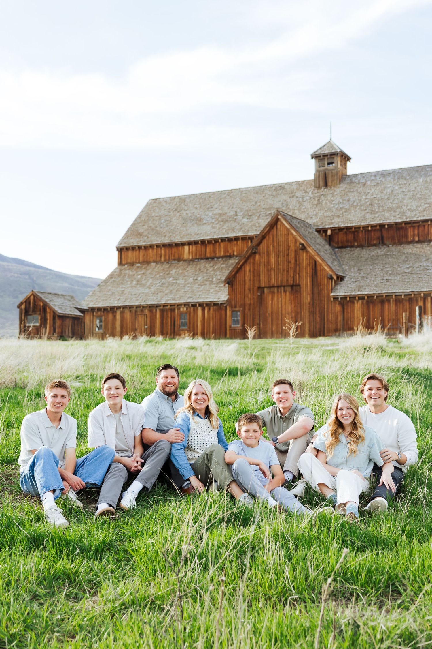 Family in front of barn at Historic Tate Barn photography by Av Potter Photo a Utah wedding and lifestyle photographer