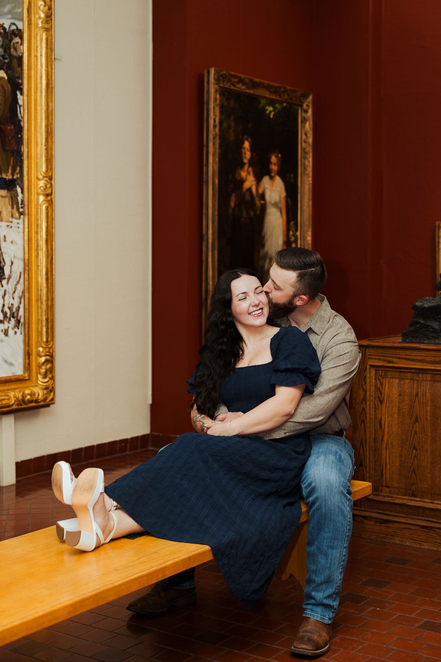 Couple sitting on bench at the Springville Art Museum photography by Av Potter Photo a Utah wedding and lifestyle photographer