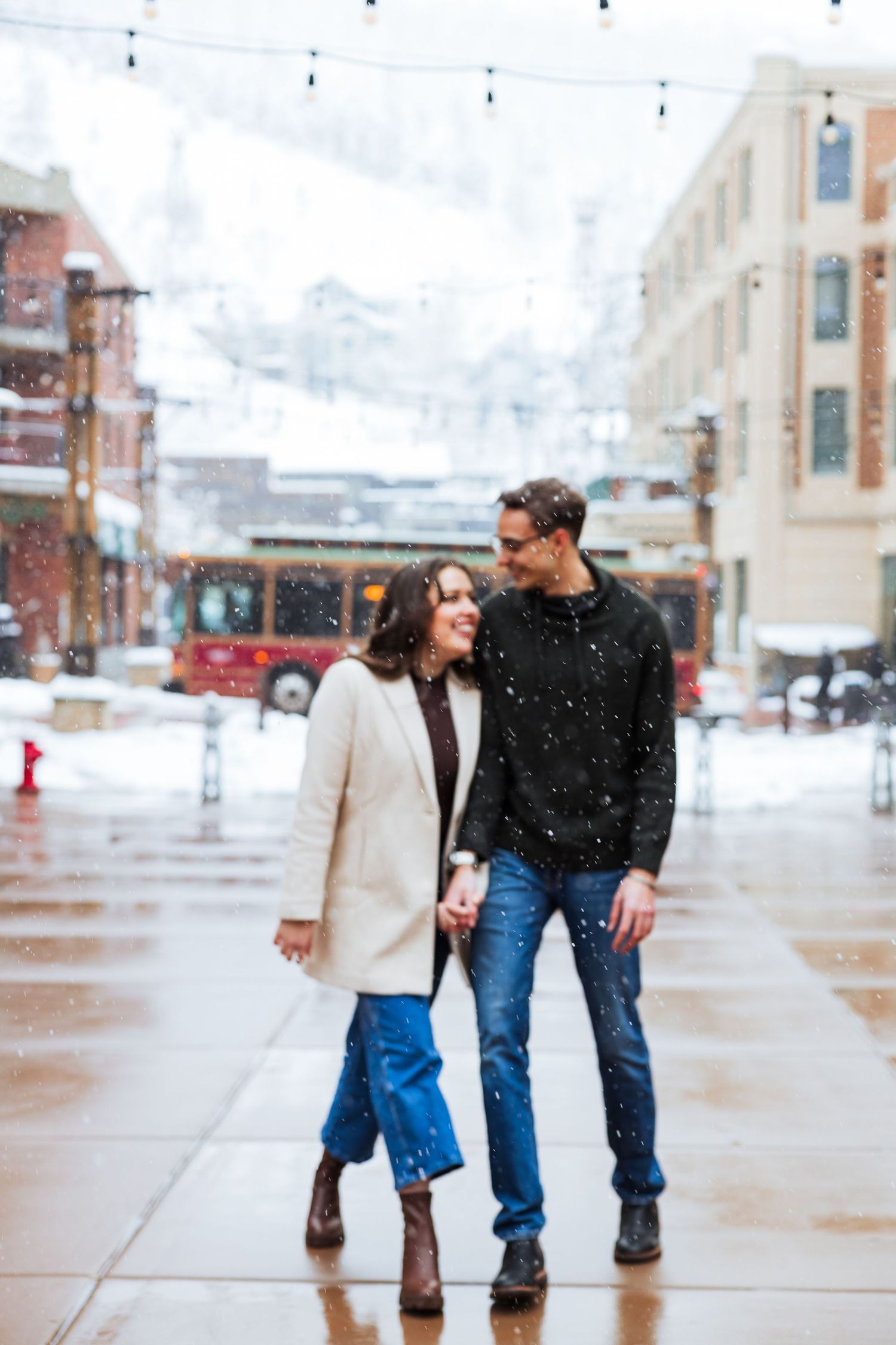 Couple walking during winter at Park City Main Street photography by Av Potter Photo a Utah wedding and lifestyle photographer