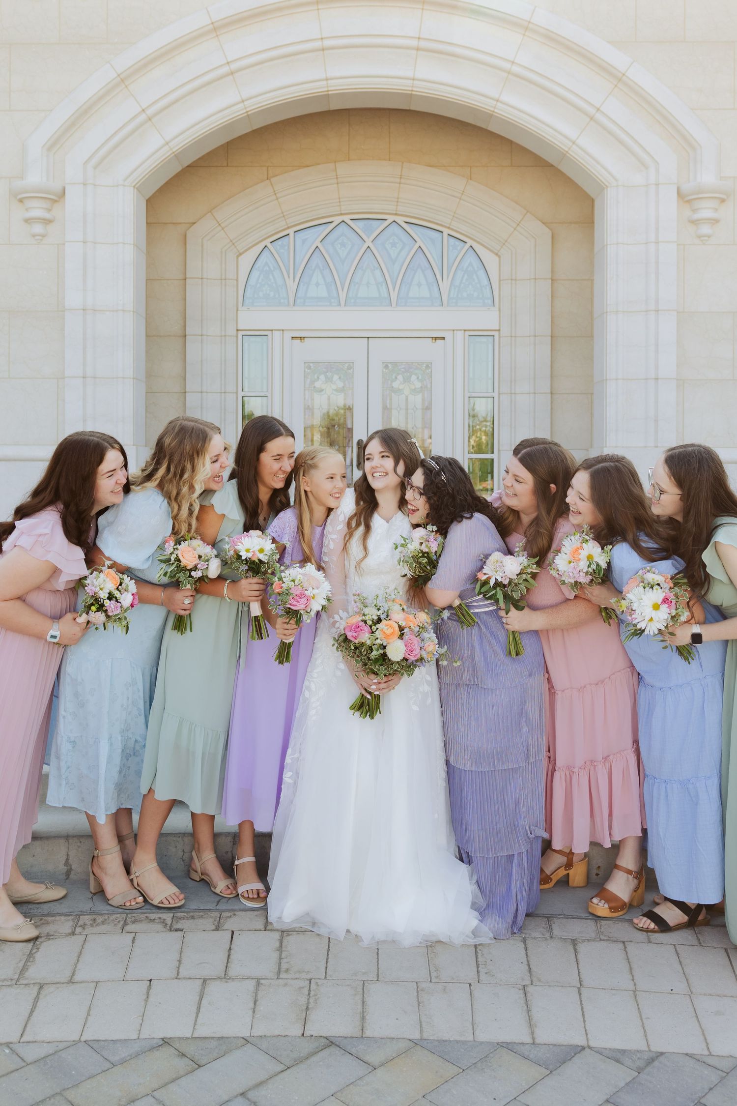 Bride and bridesmaids at the Taylorsville Temple photography by Av Potter Photo a Utah wedding and lifestyle photographer