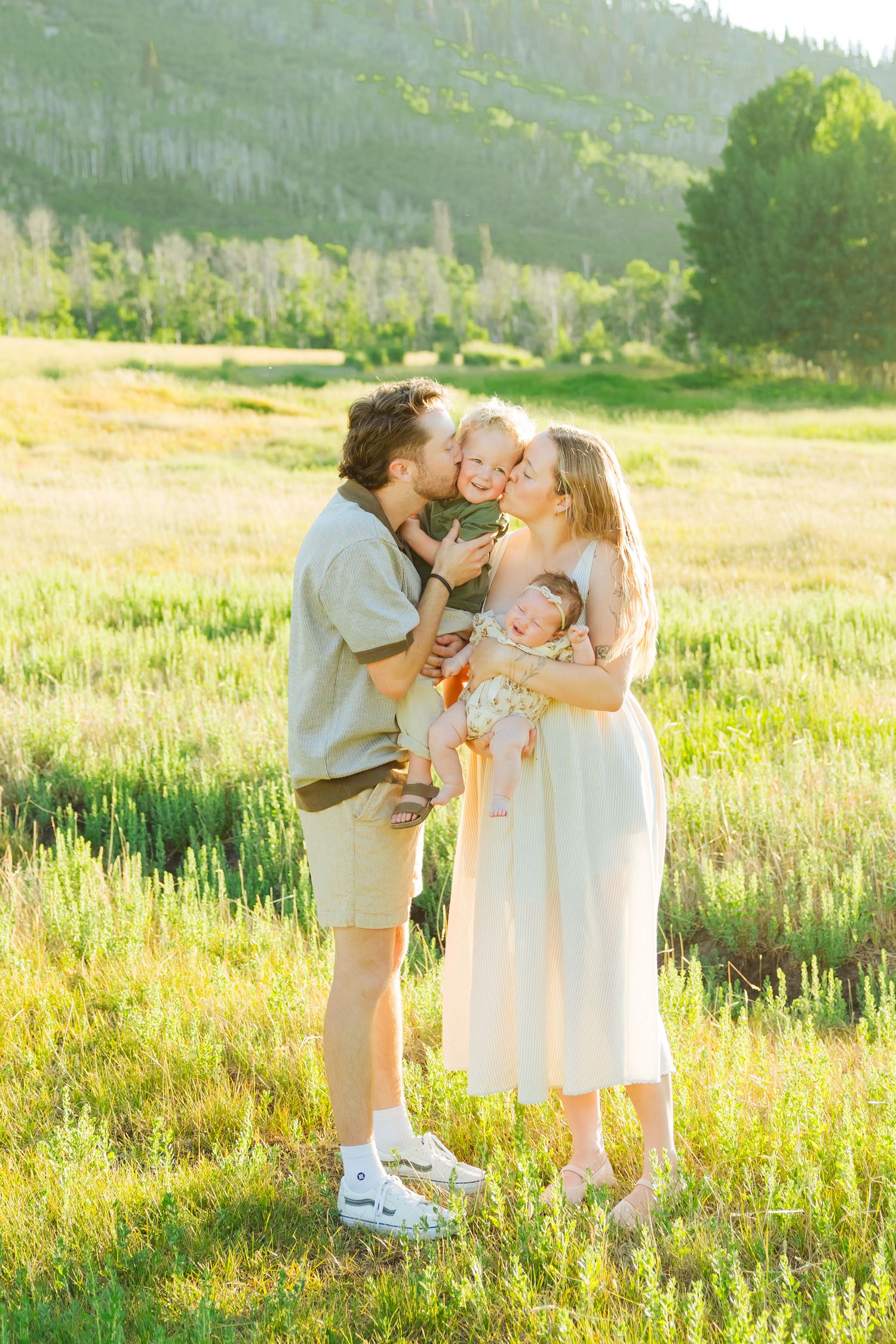 Family in field at McPolin Barn photography by Av Potter Photo a Utah wedding and lifestyle photographer
