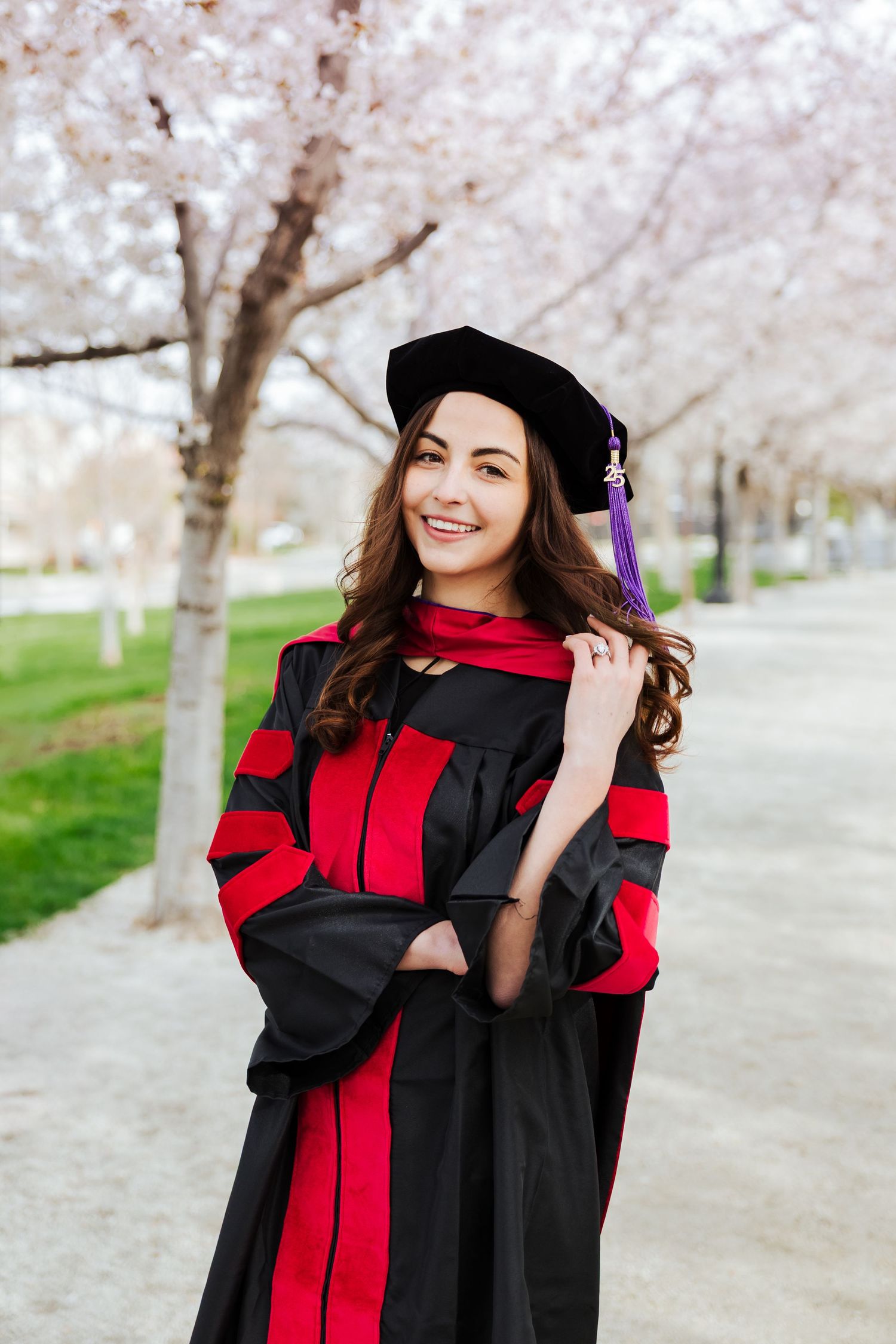 Graduate during cherry blossoms at The Utah State Capitol photography by Av Potter Photo a Utah wedding and lifestyle photographer