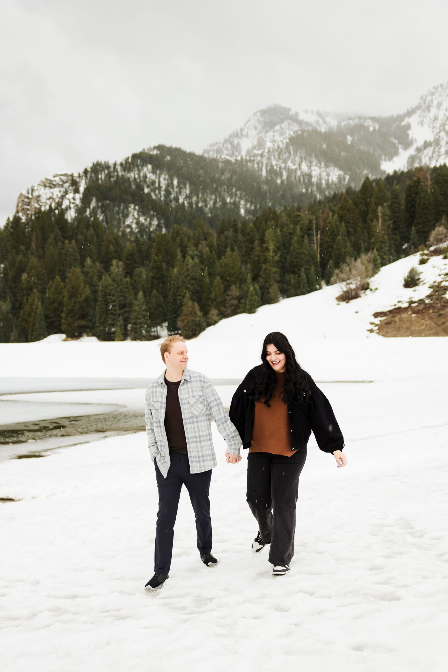 Couple walking at Tibble Fork Reservoir photography by Av Potter Photo a Utah wedding and lifestyle photographer