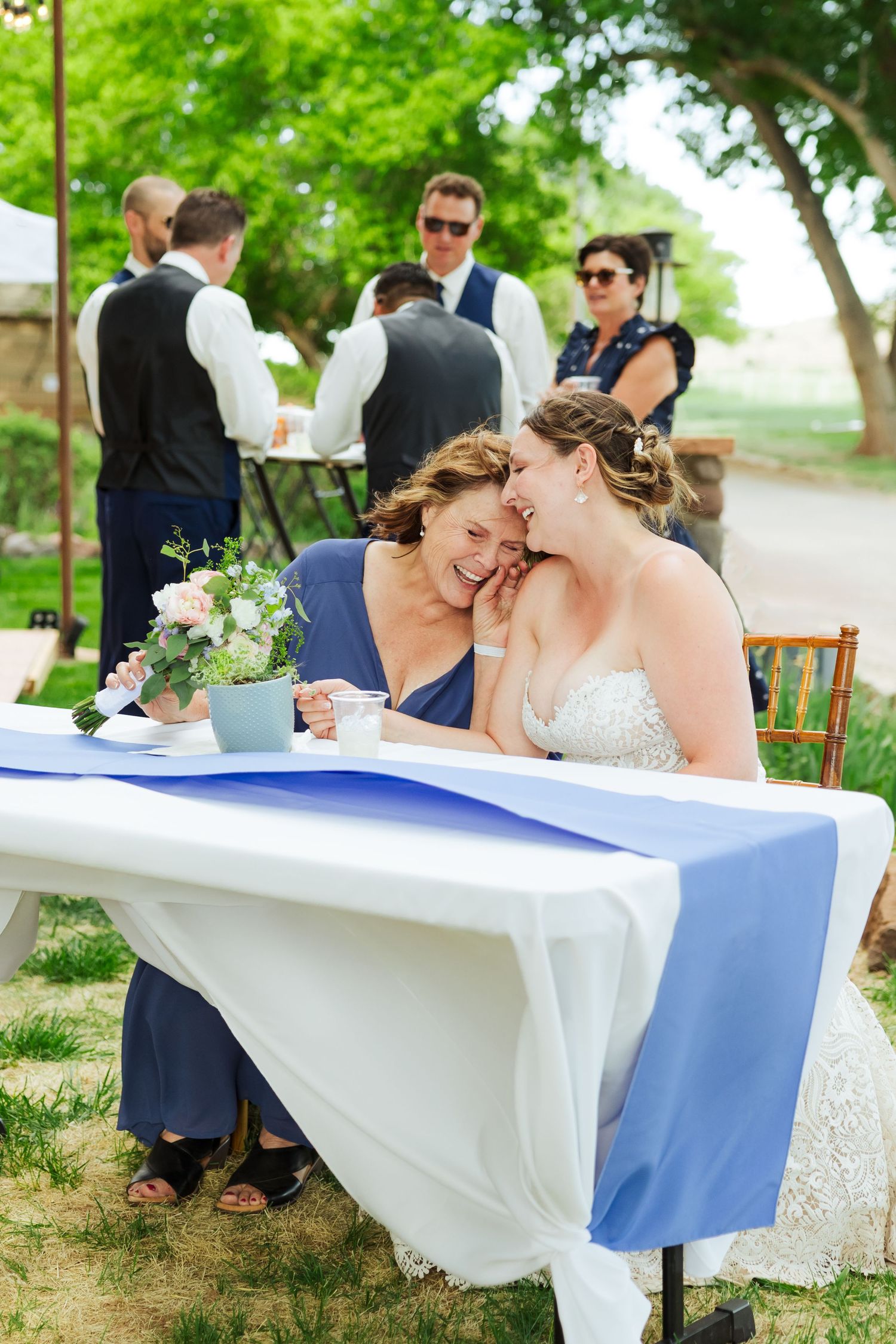 Bride and mother of bride laughing at The Lodge at Red River Ranch photography by Av Potter Photo a Utah wedding and lifestyle photographer