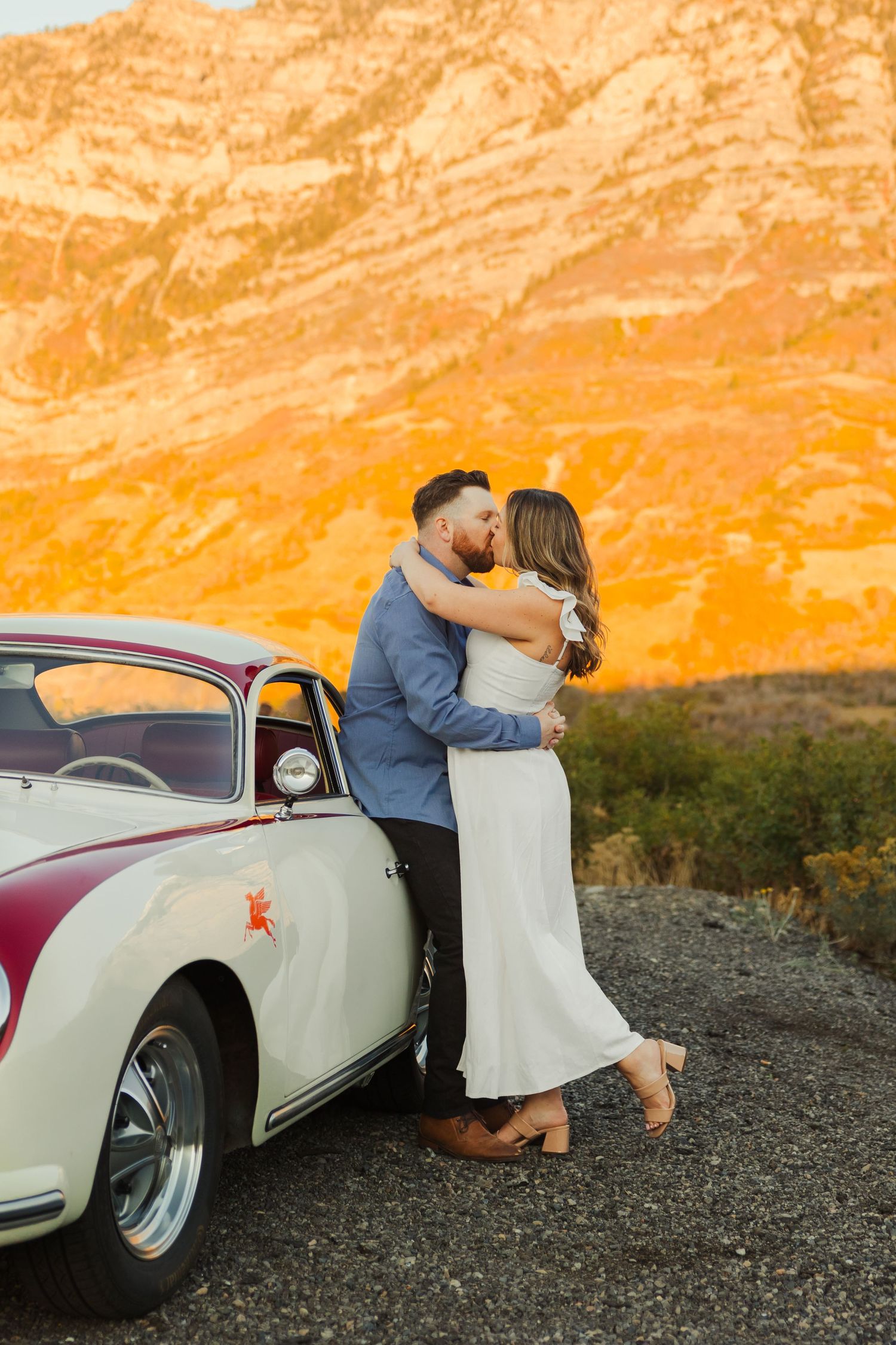 Couple kissing with vintage Porsche Kyhv Peak in Provo photography by Av Potter Photo a Utah wedding and lifestyle photographer