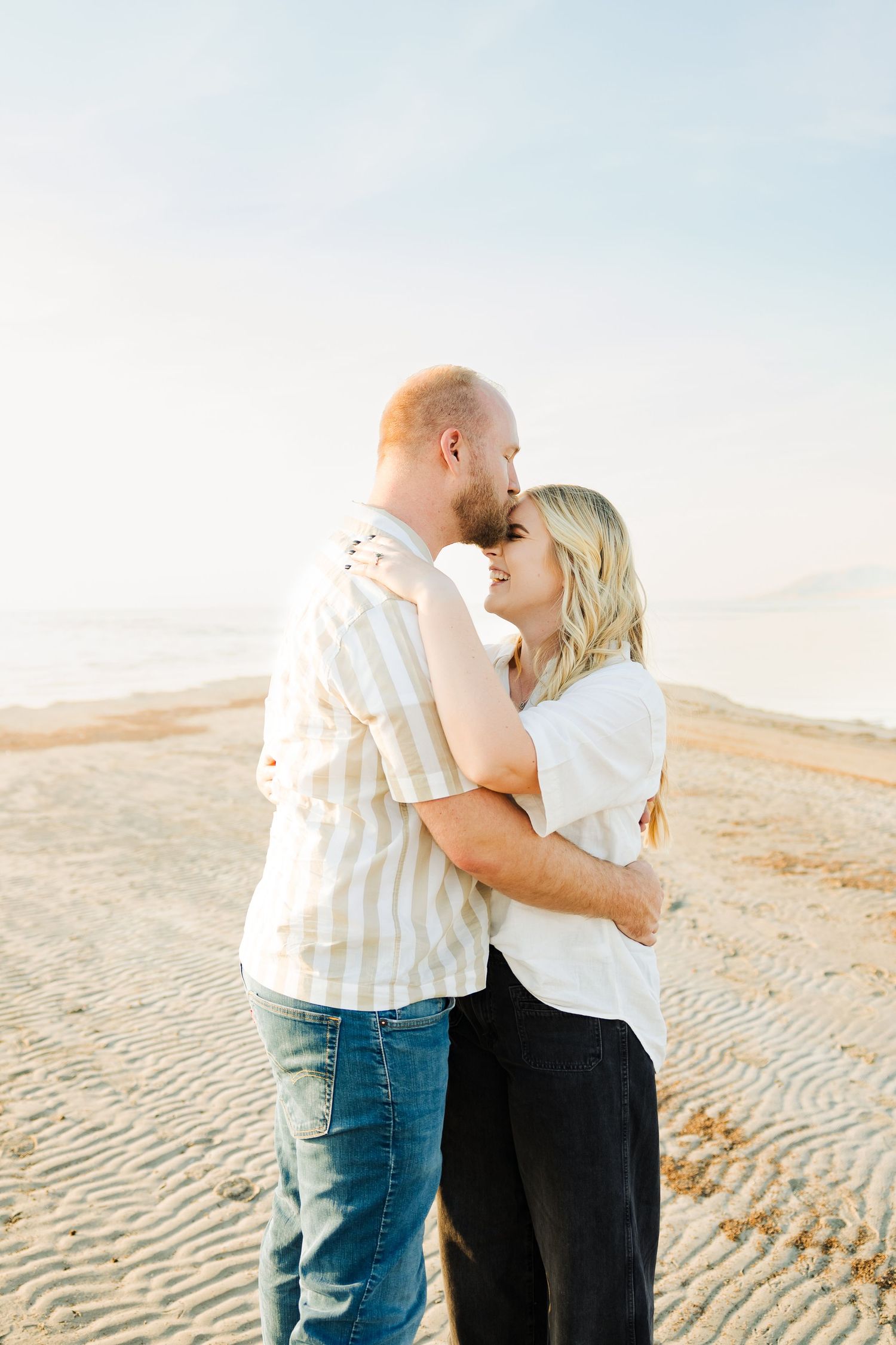 Couple hugging in lake at The Great Salt Lake photography by Av Potter Photo a Utah wedding and lifestyle photographer