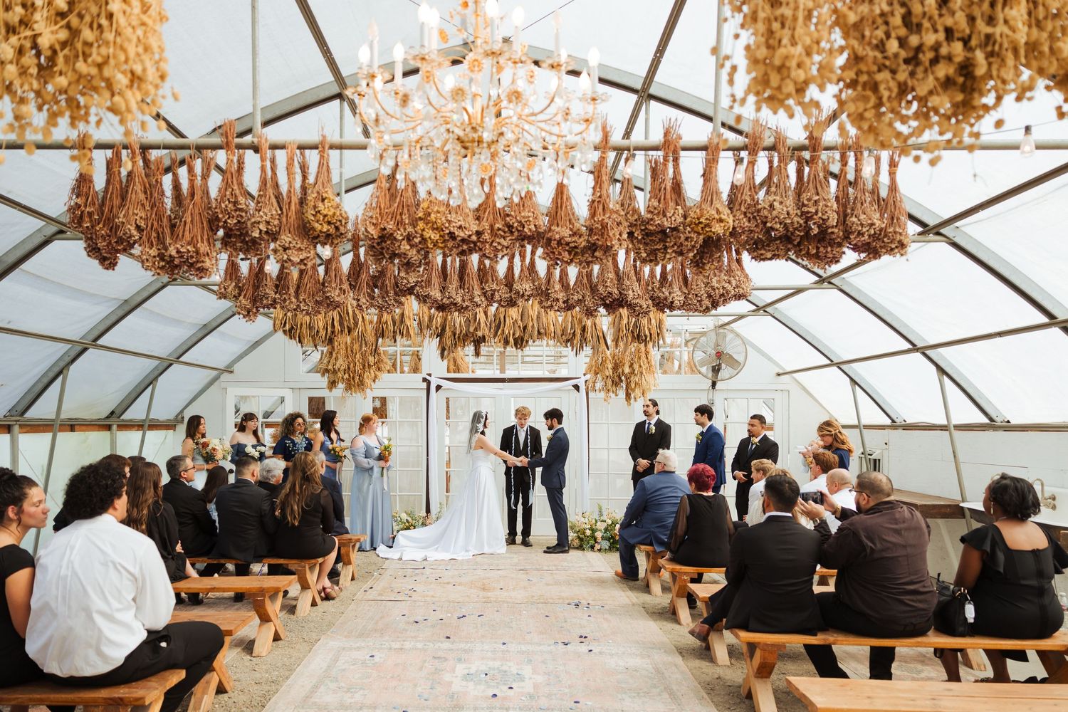 Bride and groom during ceremony at The Kinlands Greenhouse photography by Av Potter Photo a Utah wedding and lifestyle photographer