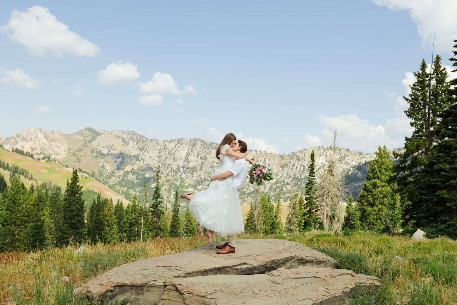 Bride and groom on rock at Albion Basin photography by Av Potter Photo a Utah wedding and lifestyle photographer