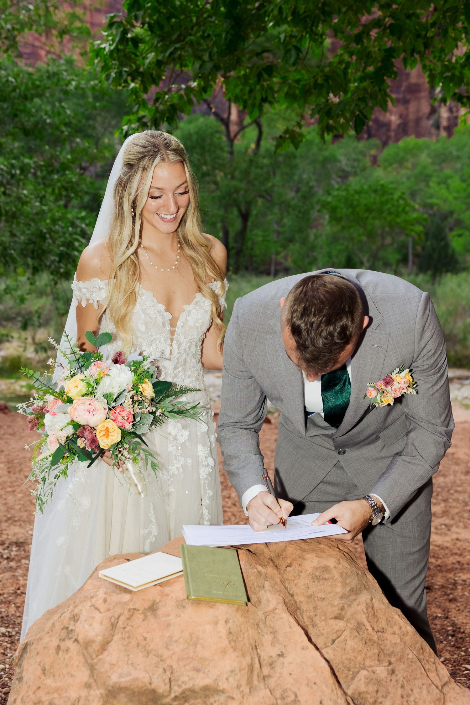Bride and groom signing marriage license at Zion National Park photography by Av Potter Photo a Utah wedding and lifestyle photographer