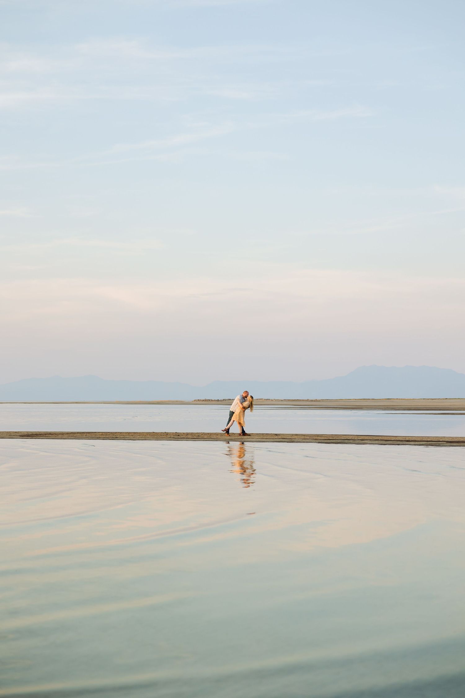 Couple dipping in lake at The Great Salt Lake photography by Av Potter Photo a Utah wedding and lifestyle photographer