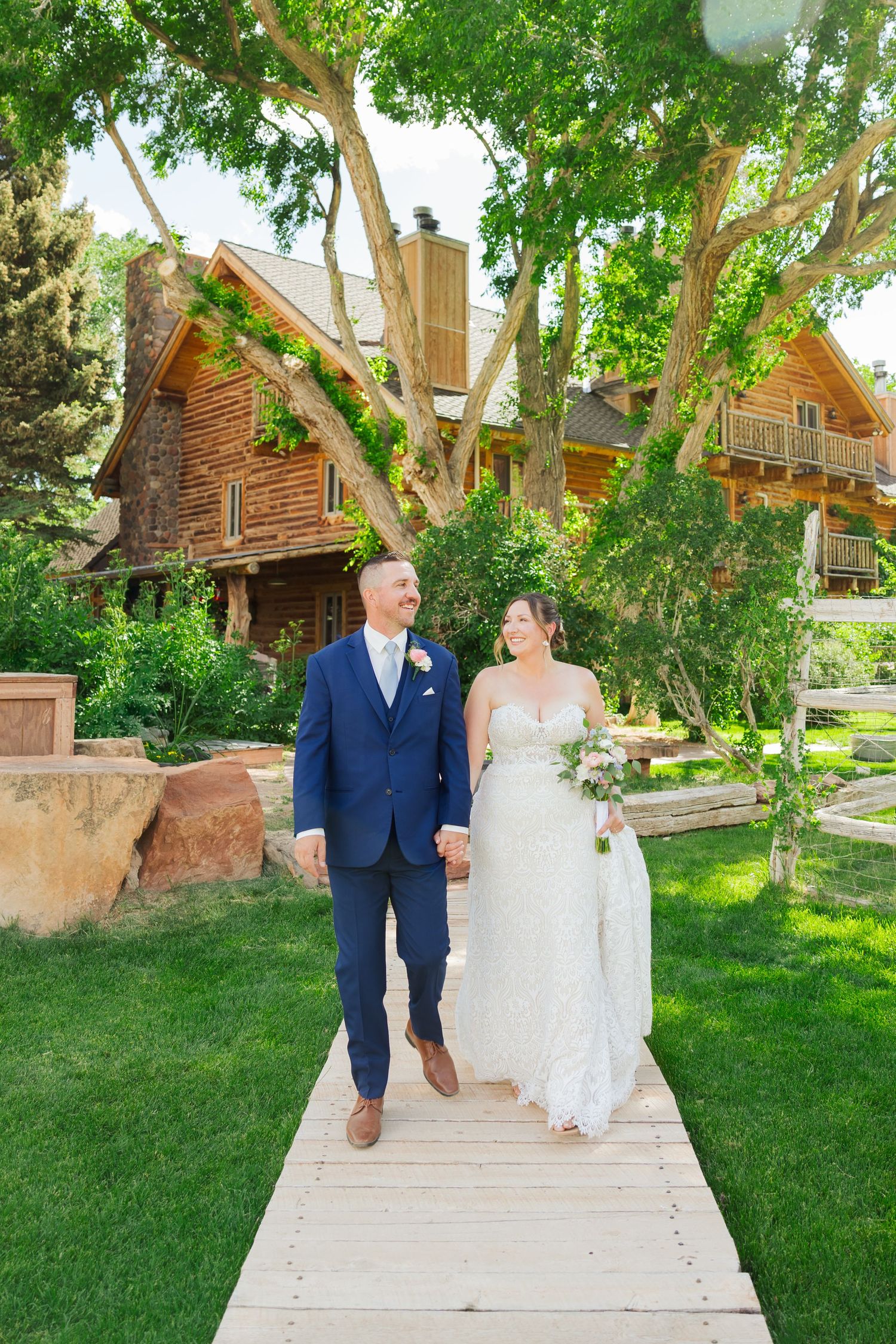 Bride and groom walking at The Lodge at Red River Ranch photography by Av Potter Photo a Utah wedding and lifestyle photographer