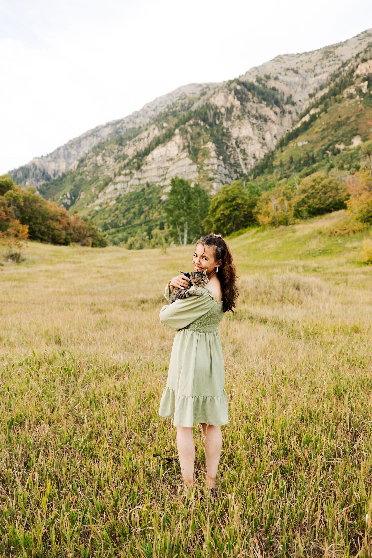 Girl with cat in field at Buffalo Peak photography by Av Potter Photo a Utah wedding and lifestyle photographer