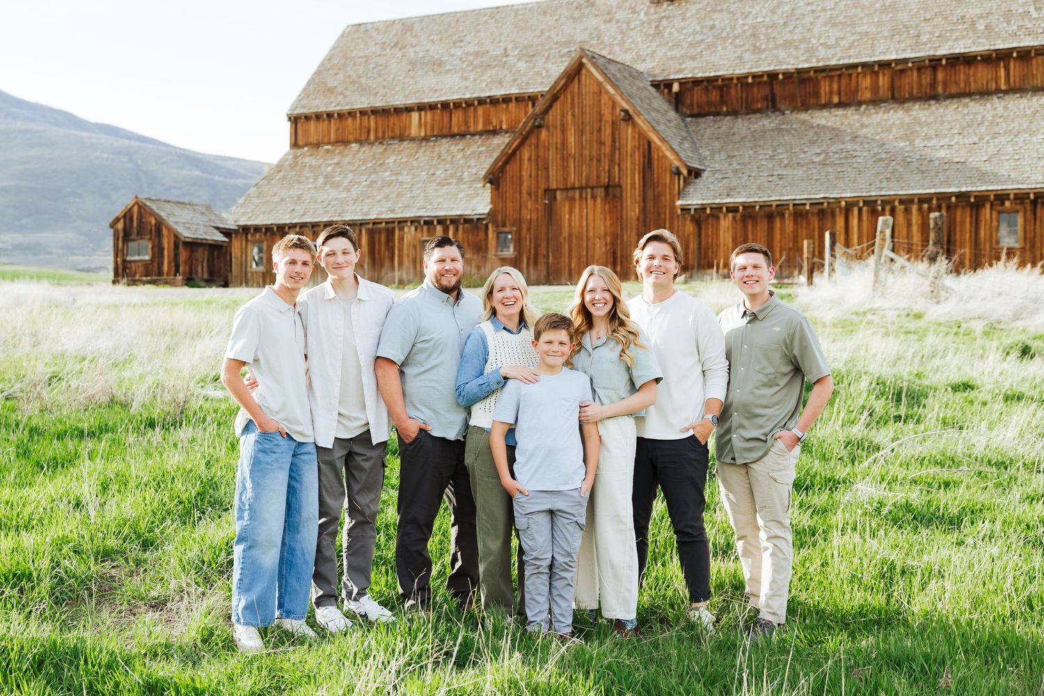 Family in front of barn at Historic Tate Barn photography by Av Potter Photo a Utah wedding and lifestyle photographer