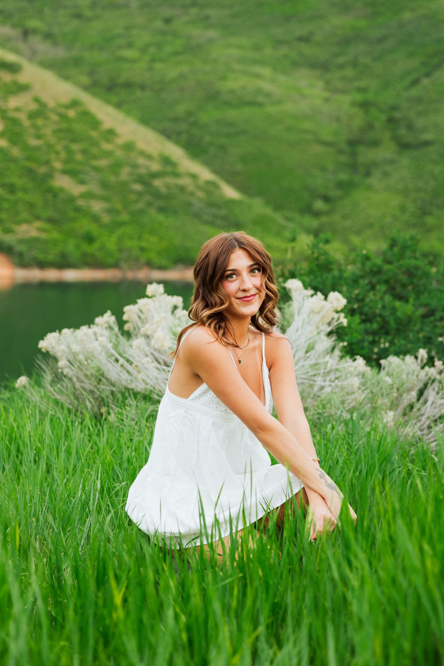 Senior girl in field at Little Dell Reservoir photography by Av Potter Photo a Utah wedding and lifestyle photographer