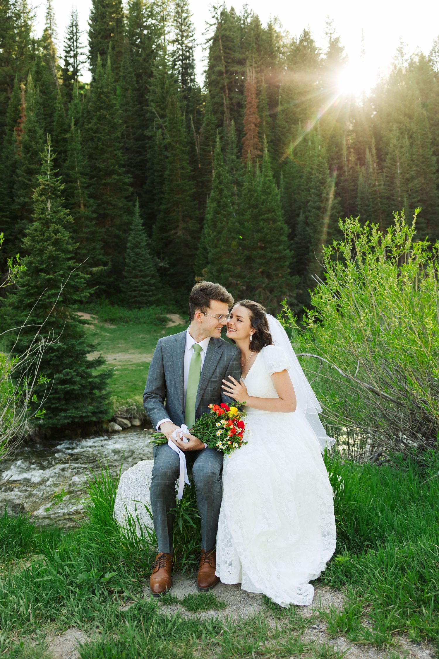 Bride and groom sitting at Jordan Pines Campground photography by Av Potter Photo a Utah wedding and lifestyle photographer