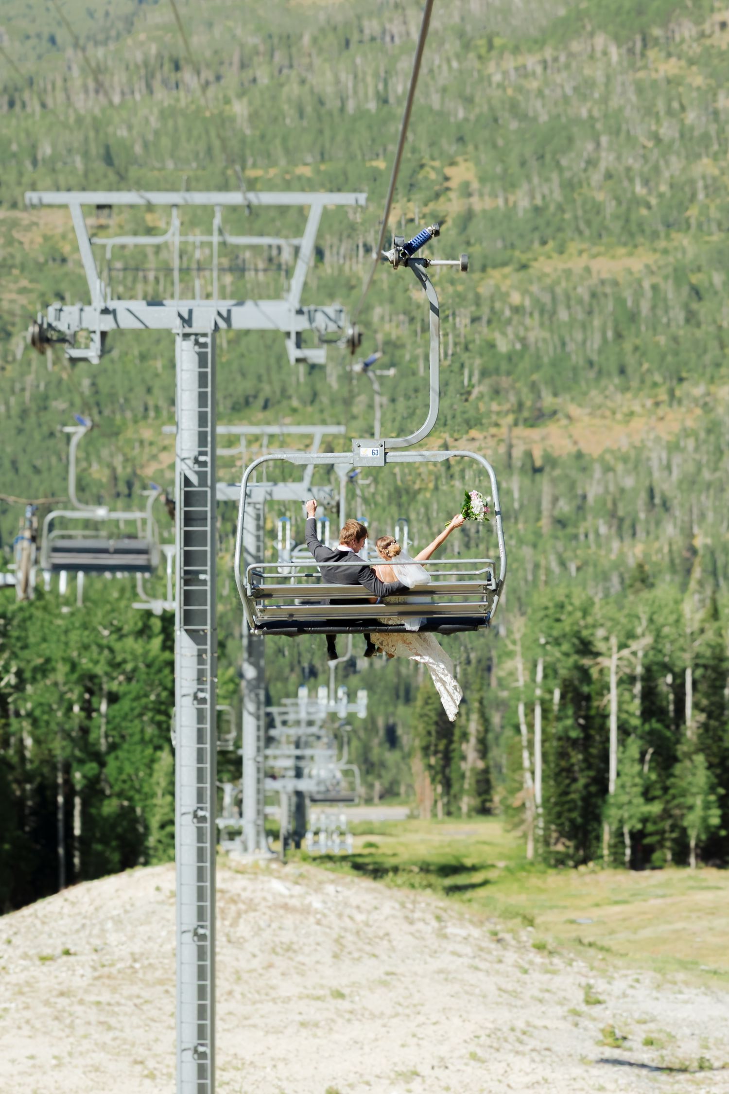 Bride and groom on ski lift at Solitude Mountain Resort photography by Av Potter Photo a Utah wedding and lifestyle photographer