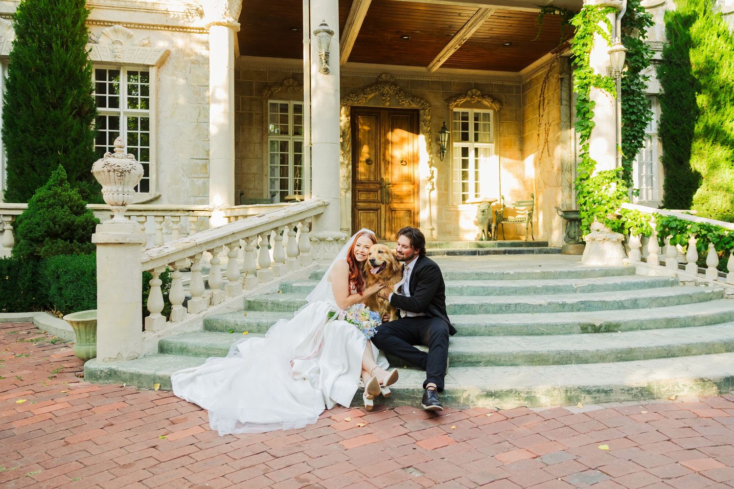 Bride and groom with dog on stairs at La Caille photography by Av Potter Photo a Utah wedding and lifestyle photographer