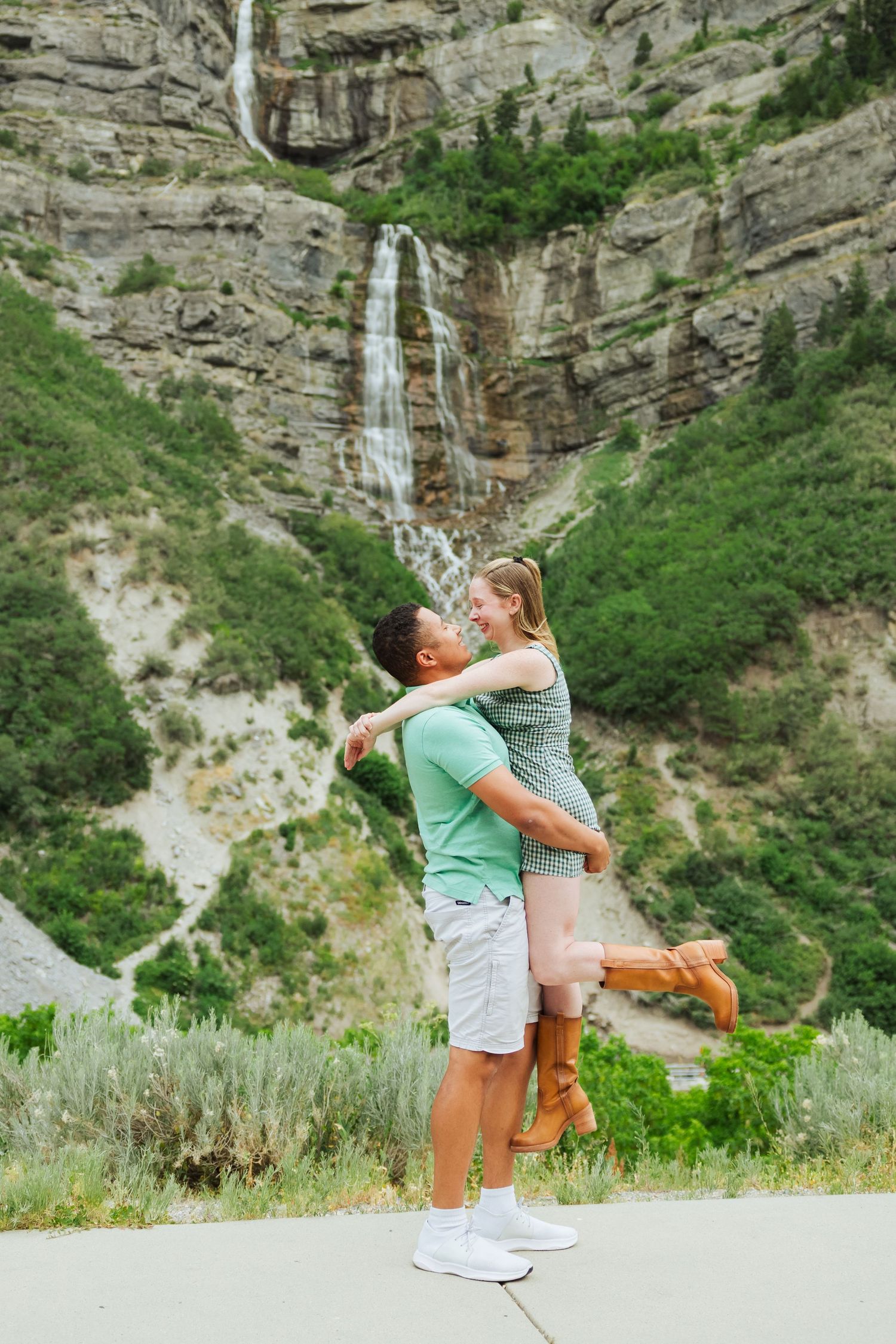 Couple in front of Bridal Veil Falls photography by Av Potter Photo a Utah wedding and lifestyle photographer