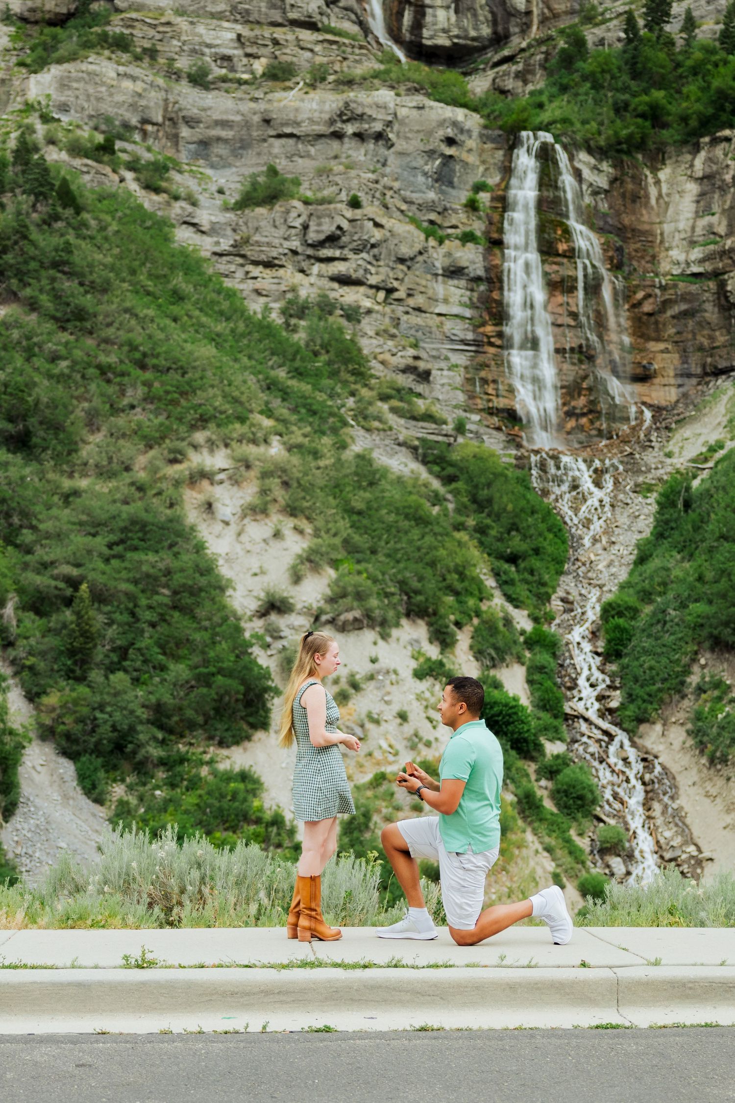 Proposal in front of Bridal Veil Falls photography by Av Potter Photo a Utah wedding and lifestyle photographer