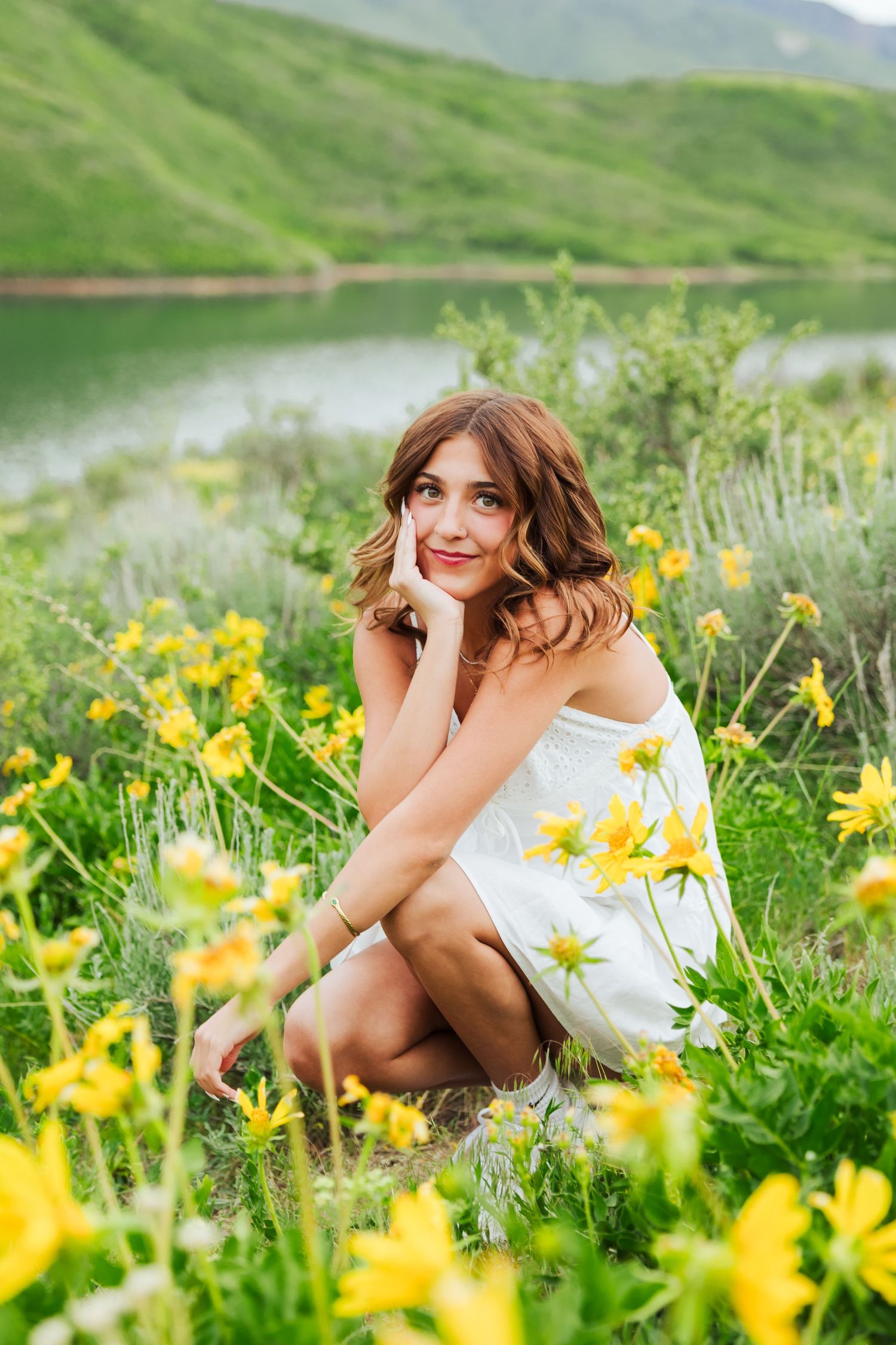Graduate in flower field at Little Dell Reservoir photography by Av Potter Photo a Utah wedding and lifestyle photographer