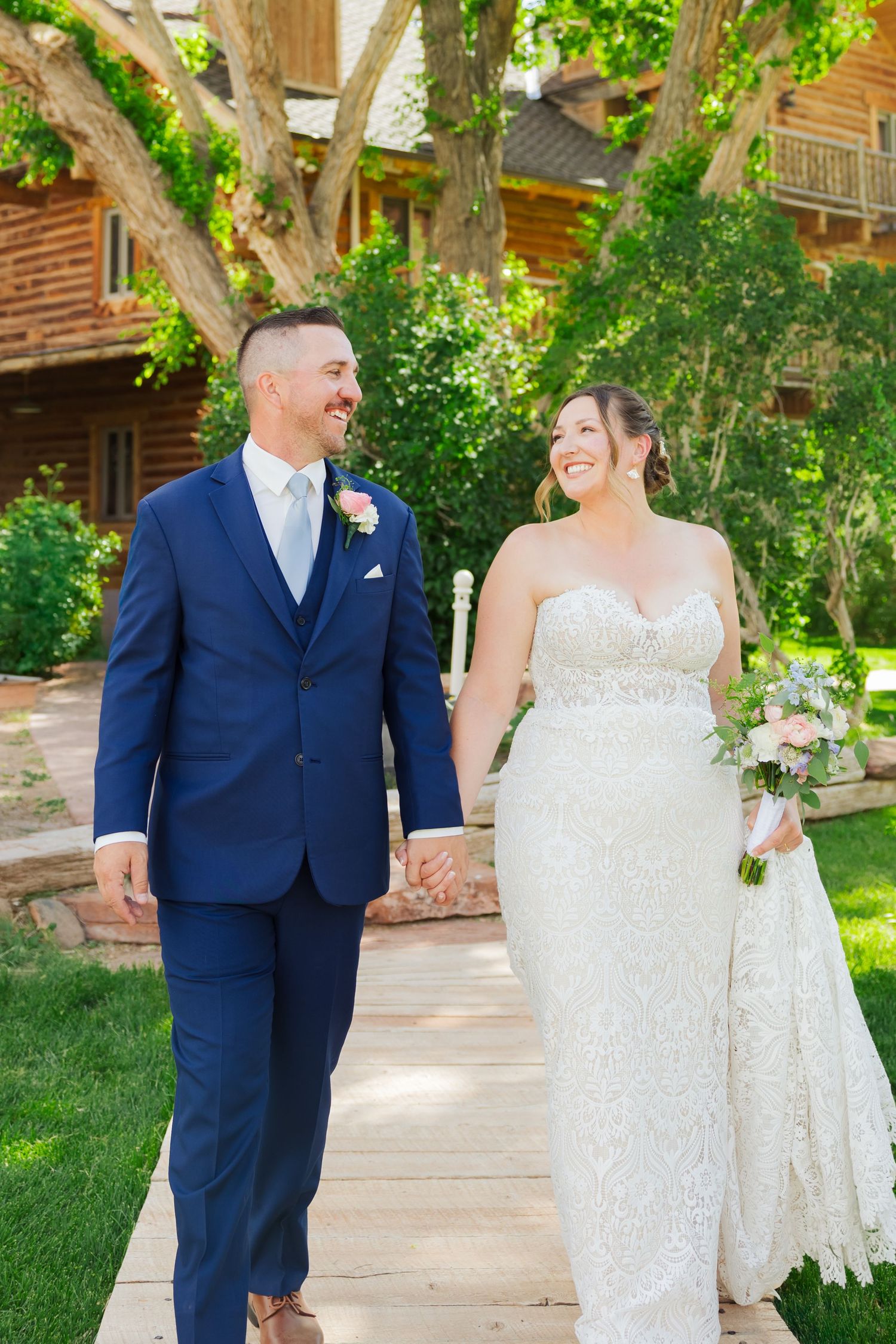 Bride and groom walking at The Lodge of Red River Ranch photography by Av Potter Photo a Utah wedding and lifestyle photographer