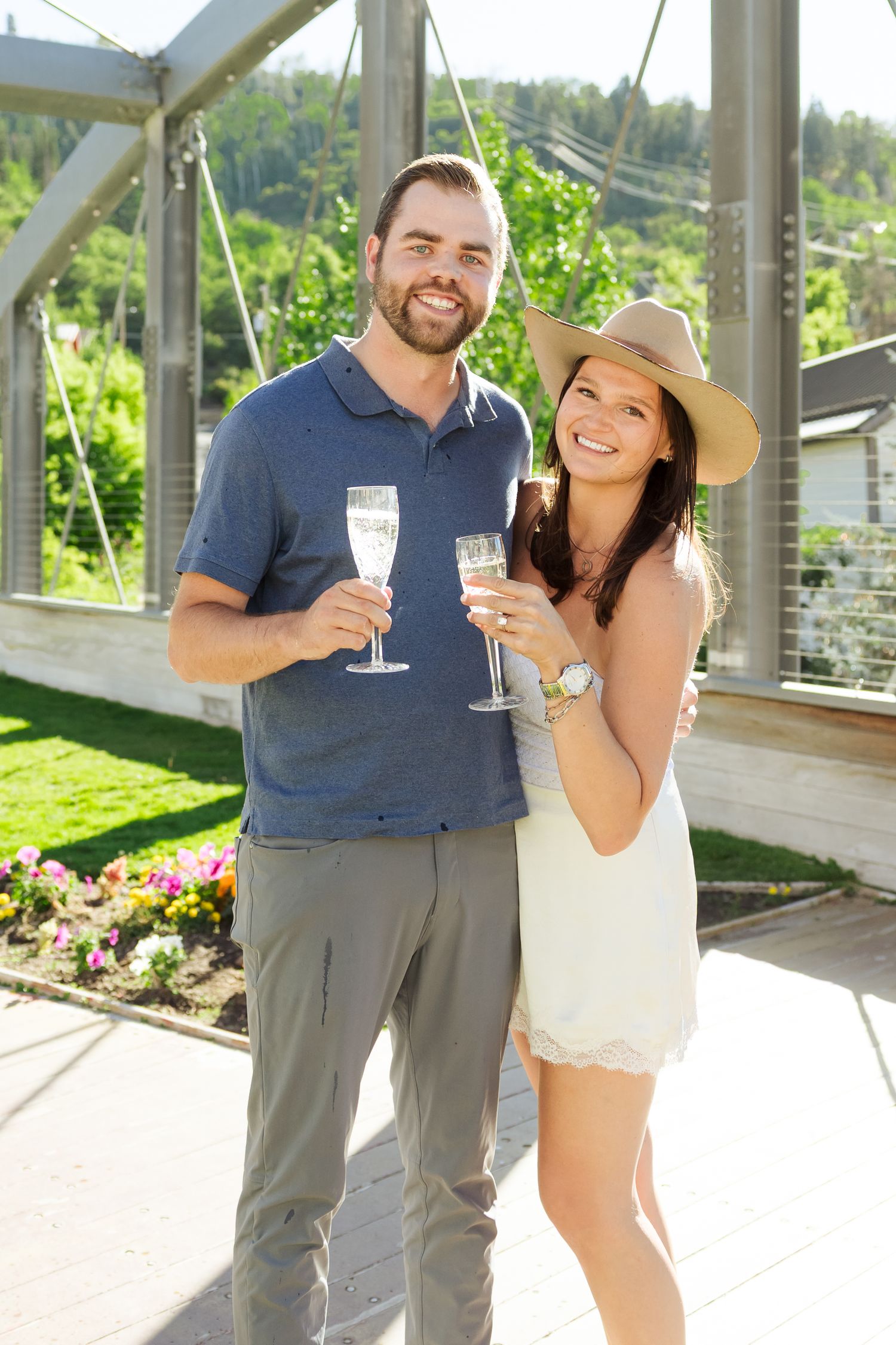 Couple with champagne during summer at Park City Main Street photography by Av Potter Photo a Utah wedding and lifestyle photographer