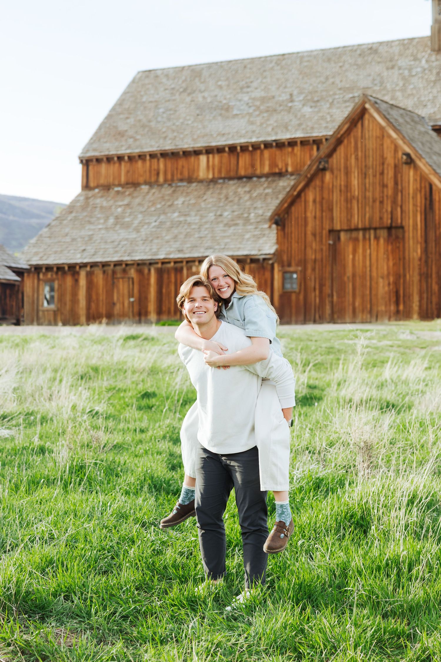 Couple in front of barn at Historic Tate Barn photography by Av Potter Photo a Utah wedding and lifestyle photographer