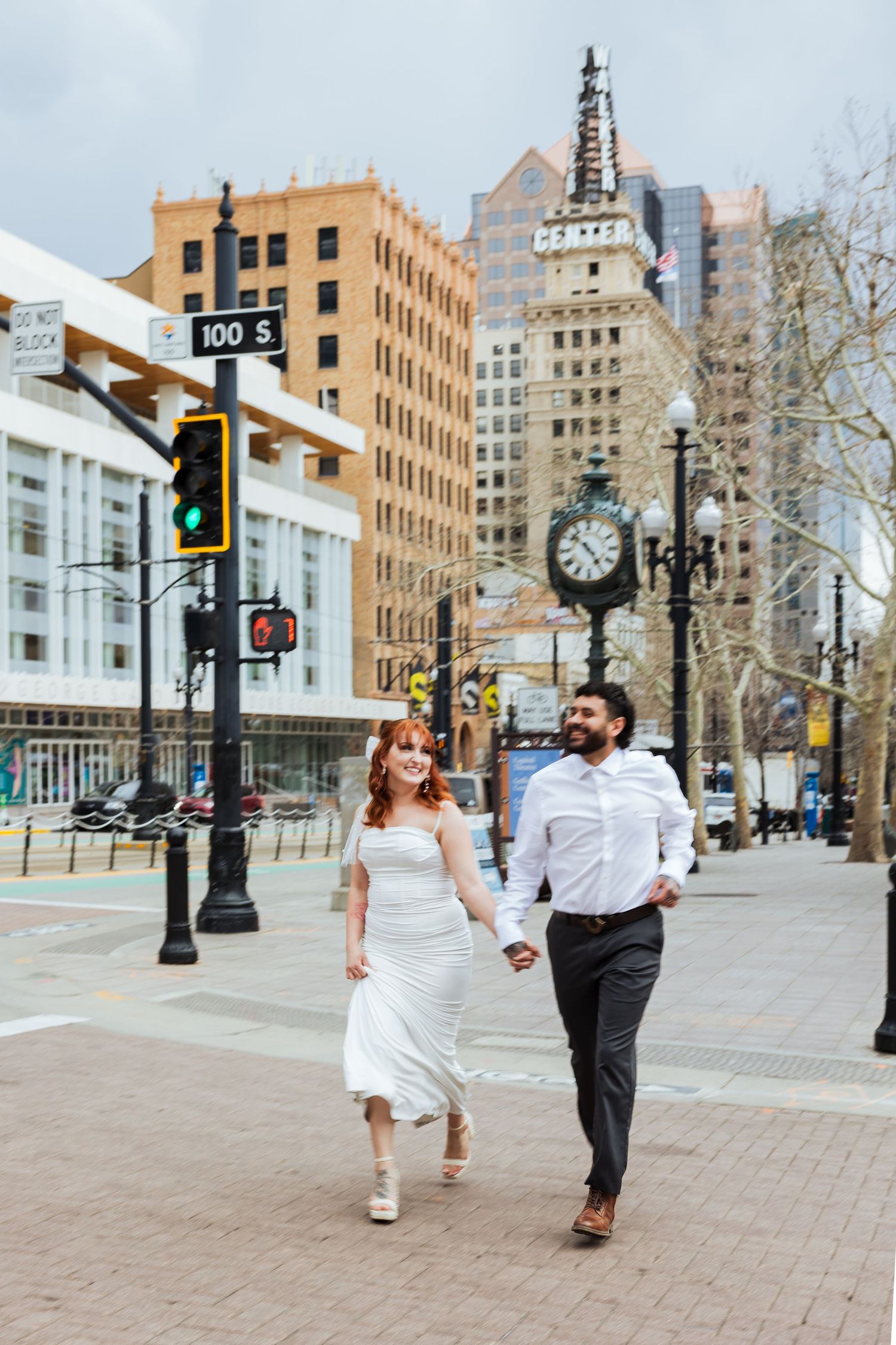 Couple walking at Salt Lake City Downtown photography by Av Potter Photo a Utah wedding and lifestyle photographer