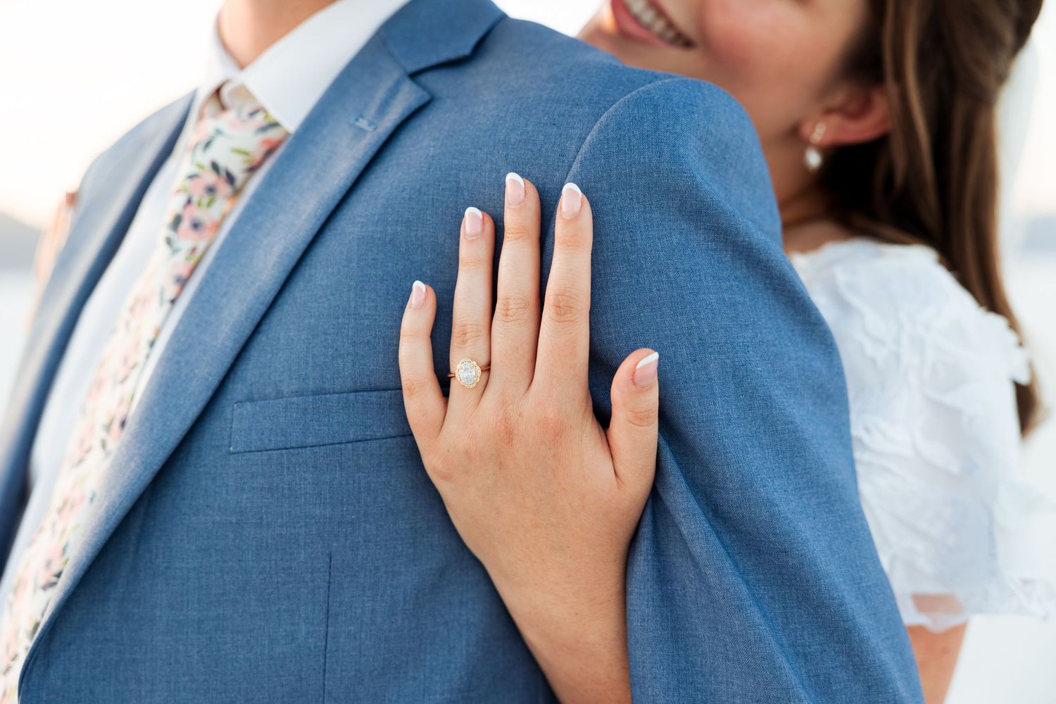 Bride hugging groom from behind at The Bonneville Salt Flats photography by Av Potter Photo a Utah wedding and lifestyle photographer
