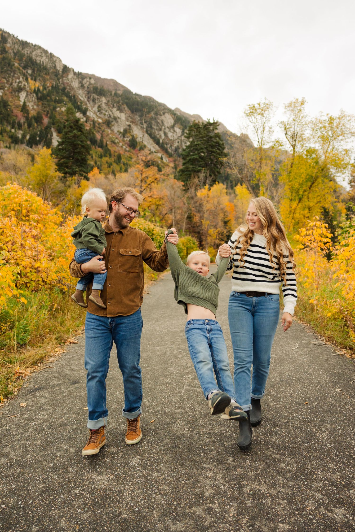 Family holding hands and walking at Tanner's Flat Campground photography by Av Potter Photo a Utah wedding and lifestyle photographer