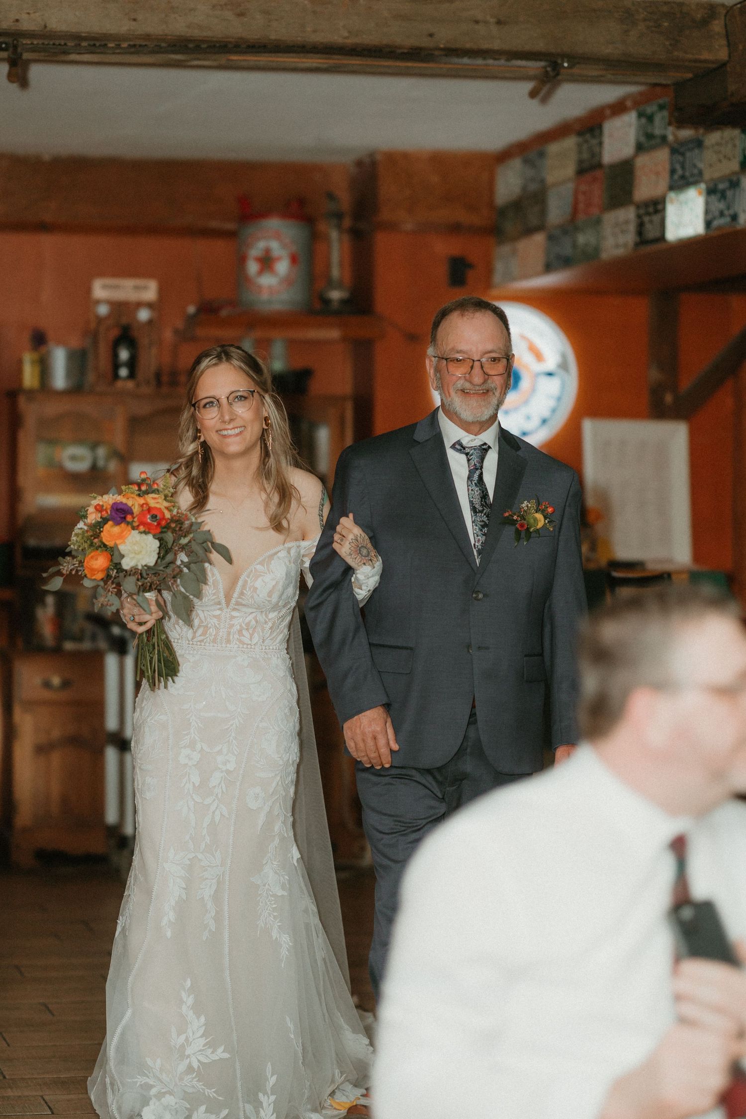 Wedding celebration in a rustic indoor venue with wooden beams and checkerboard walls.