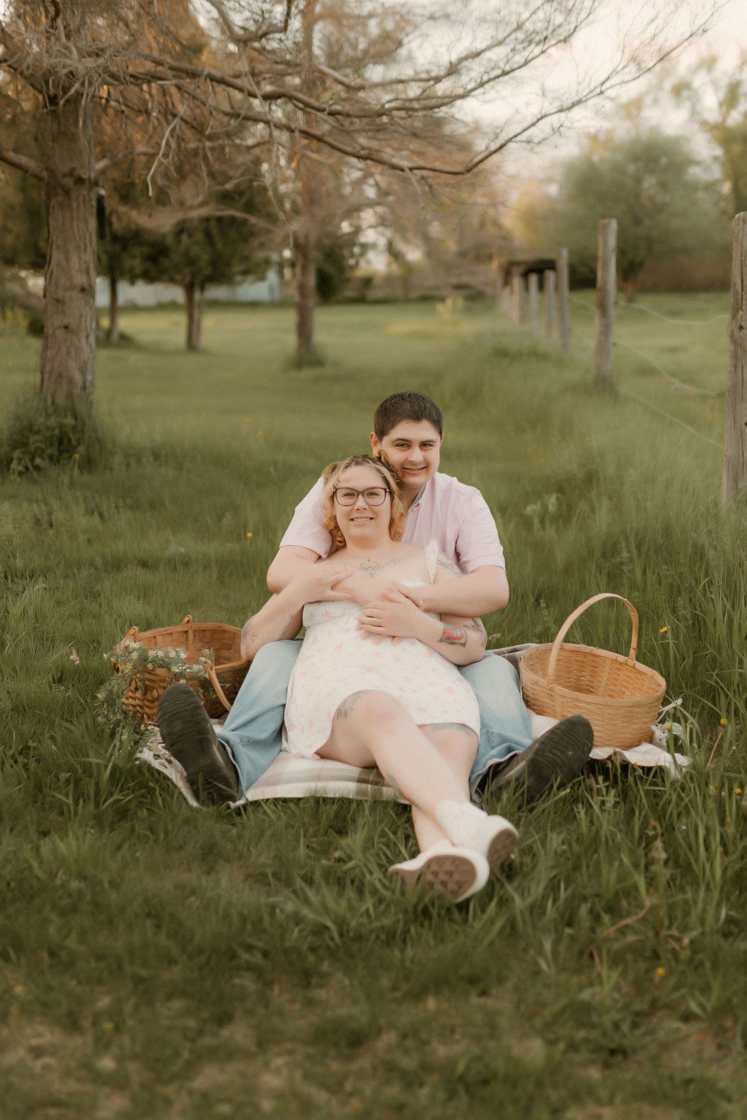 A romantic picnic scene in a grassy park with woven baskets and soft evening light.