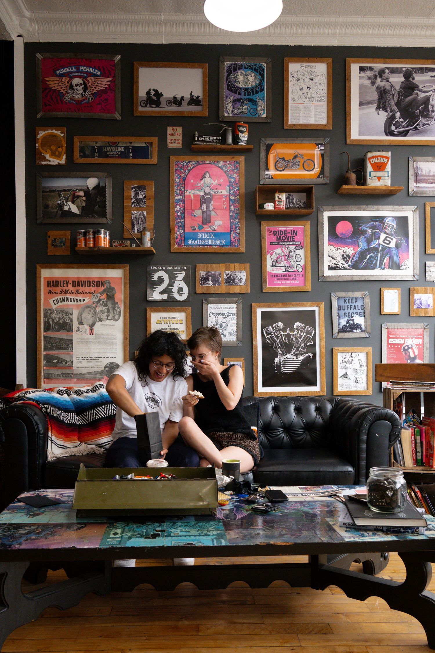 A series of five sequential photos showing someone lounging on a black leather couch against a wall filled with framed artwork.