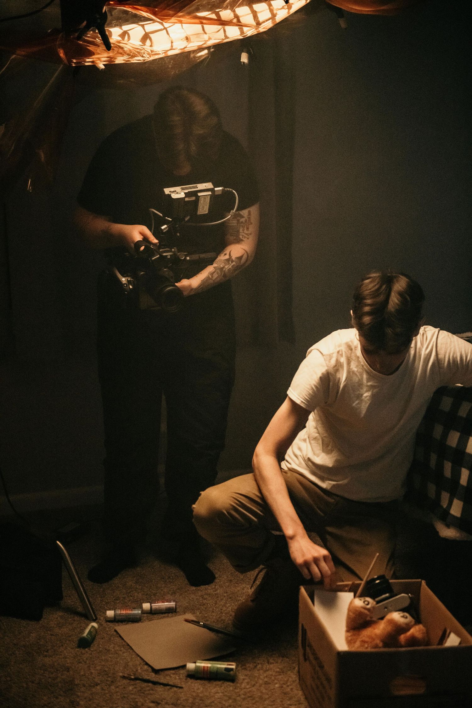 A dimly lit series of photos showing hands working with objects on a table under warm lighting.