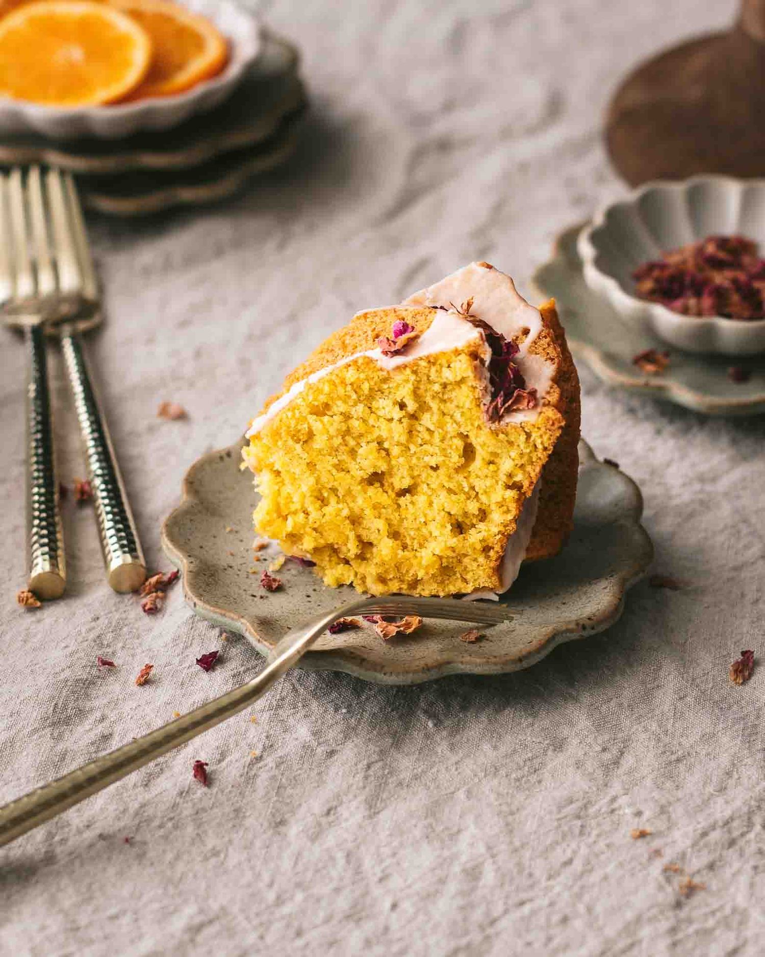 Clementine cardamom blender cake with rose icing sliced.