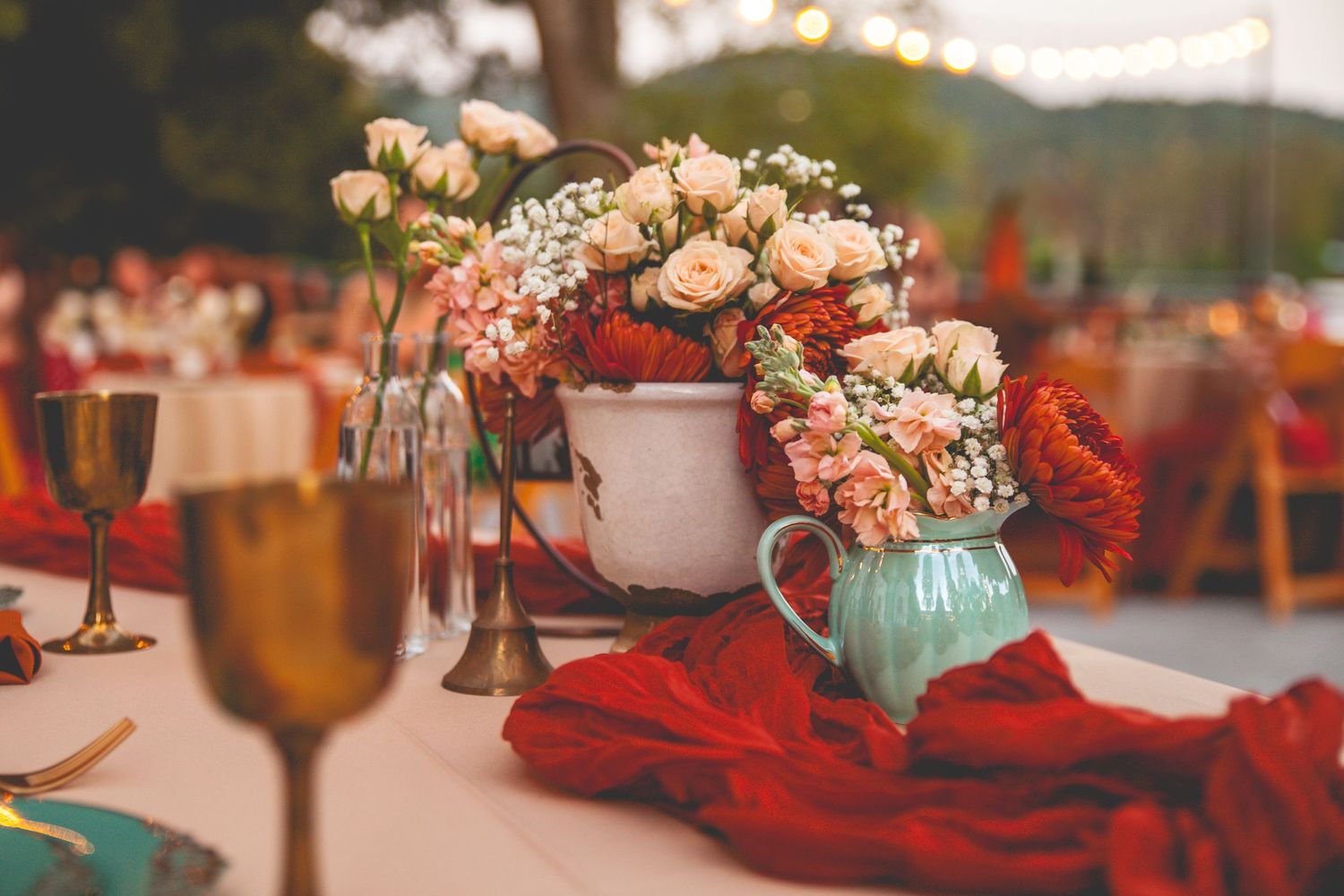 Close-up of colorful floral arrangements and table decor with string lights at a Big Bear wedding reception