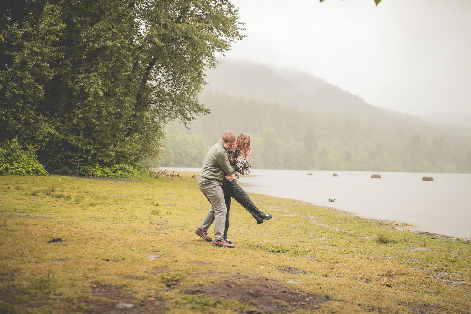 Playful couple walking together during a lakeside couples photography session