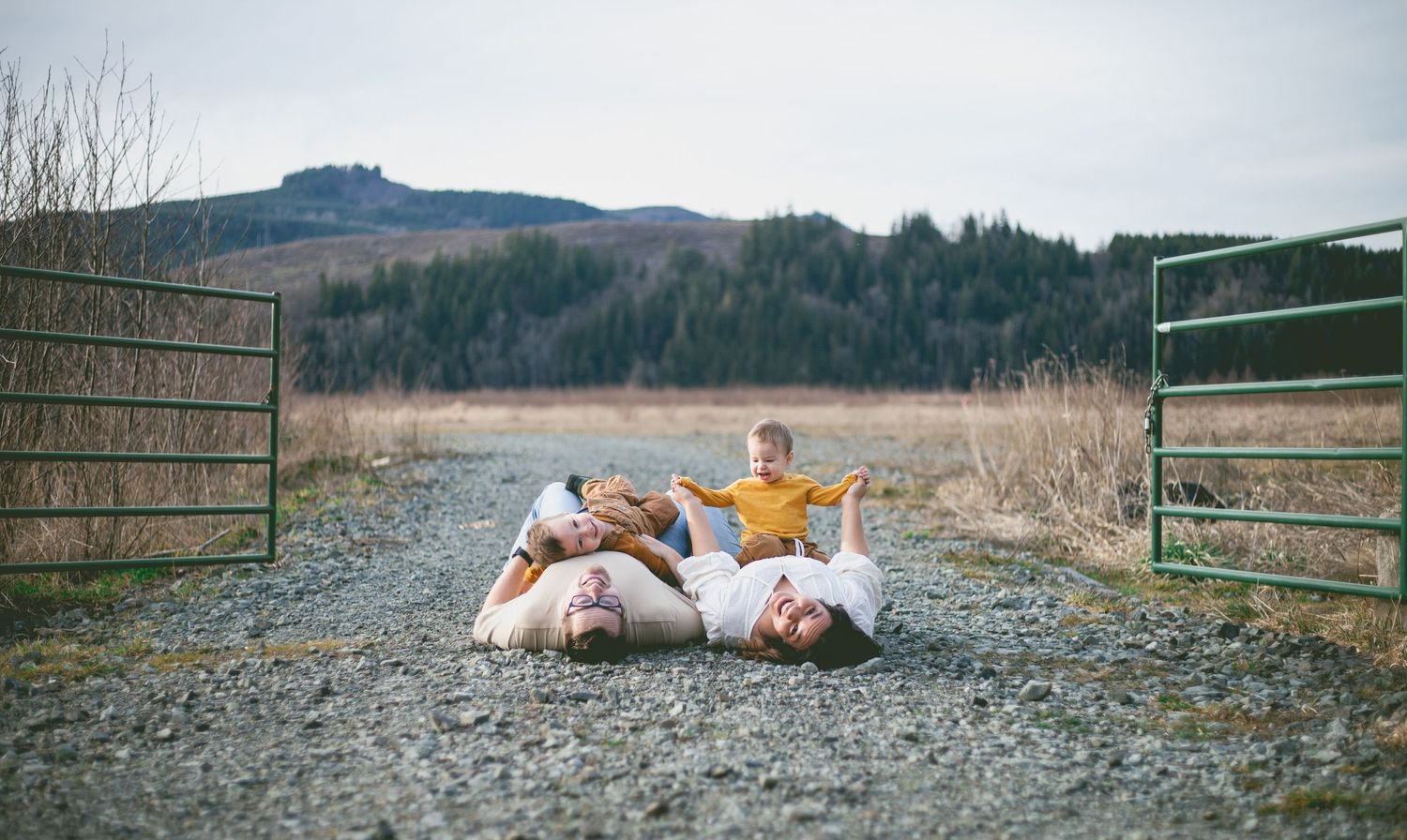 a family lying on their backs on a gravel road in big bear lake