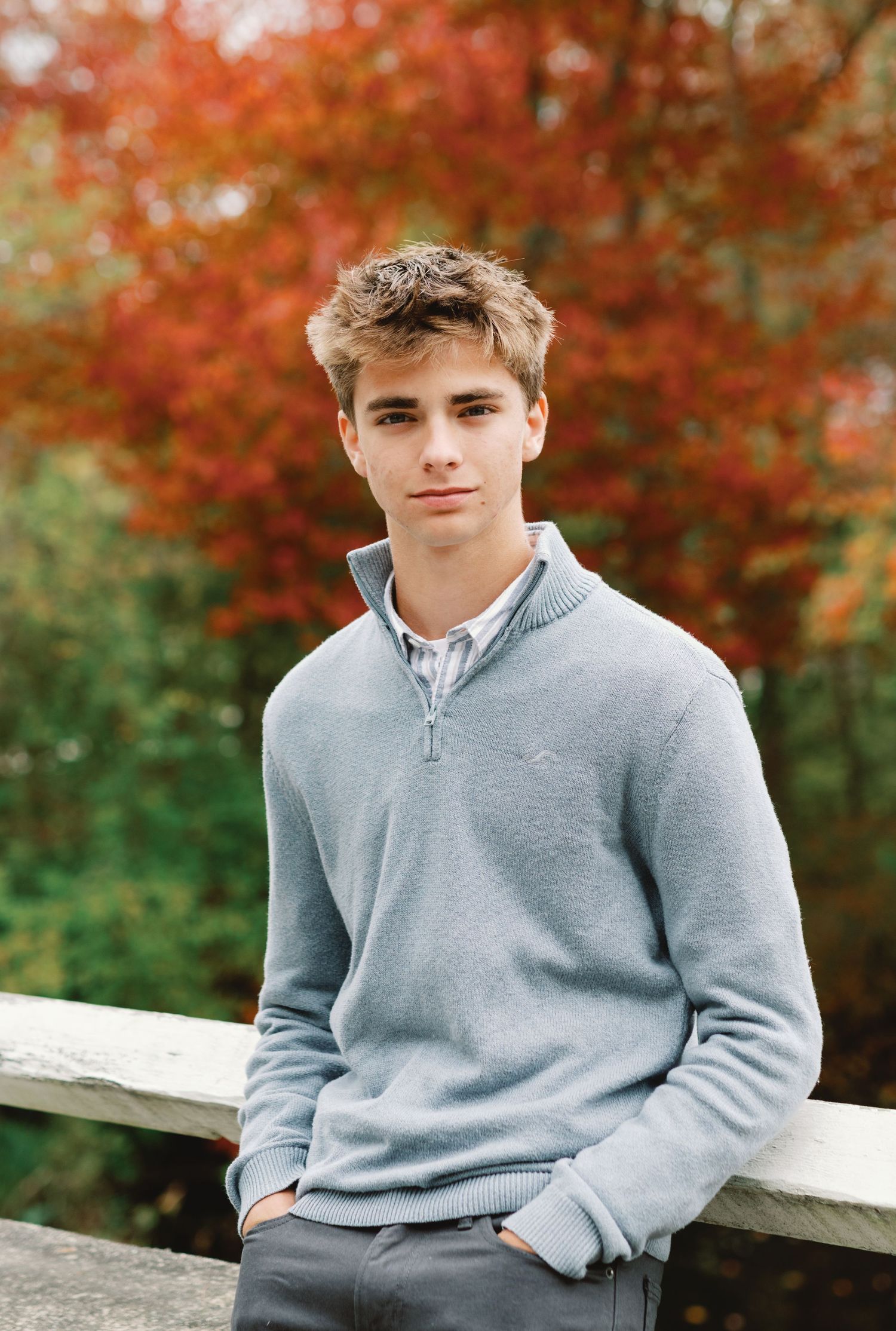 A series of casual portraits against a backdrop of vibrant autumn foliage with red maple trees.