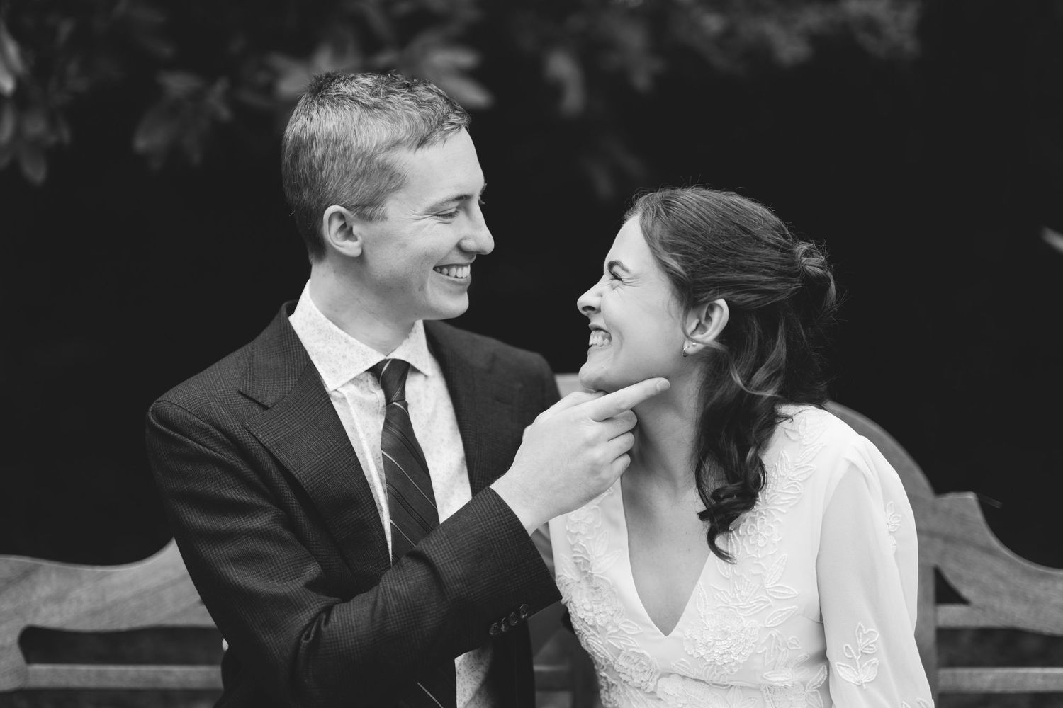A joyful bride and groom share intimate moments in black and white photographs.