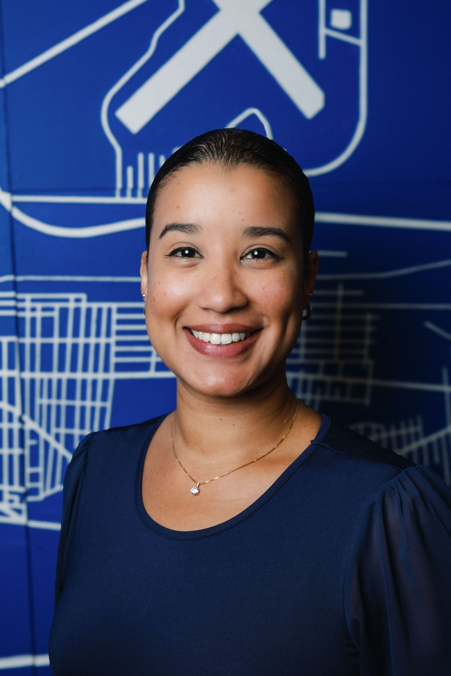 Professional headshots against a blue background with white architectural line drawings show warm, engaging expressions.